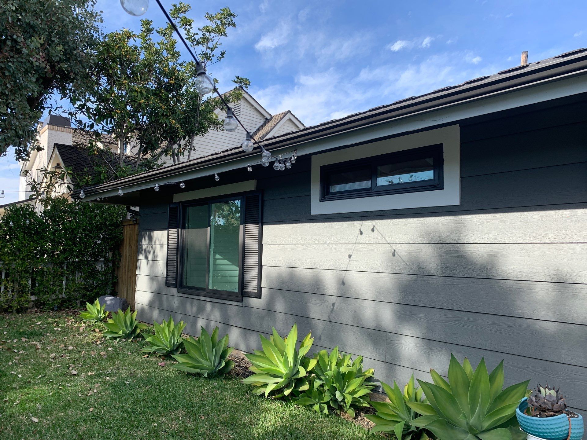 Window Installation using Milgard black vinyl windows by American Window Company