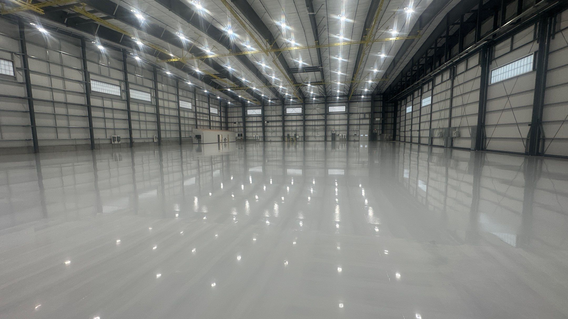 Airplane Hanger using Light Grey Commercial Penntek Epoxy by Croc Coatings, LLC
