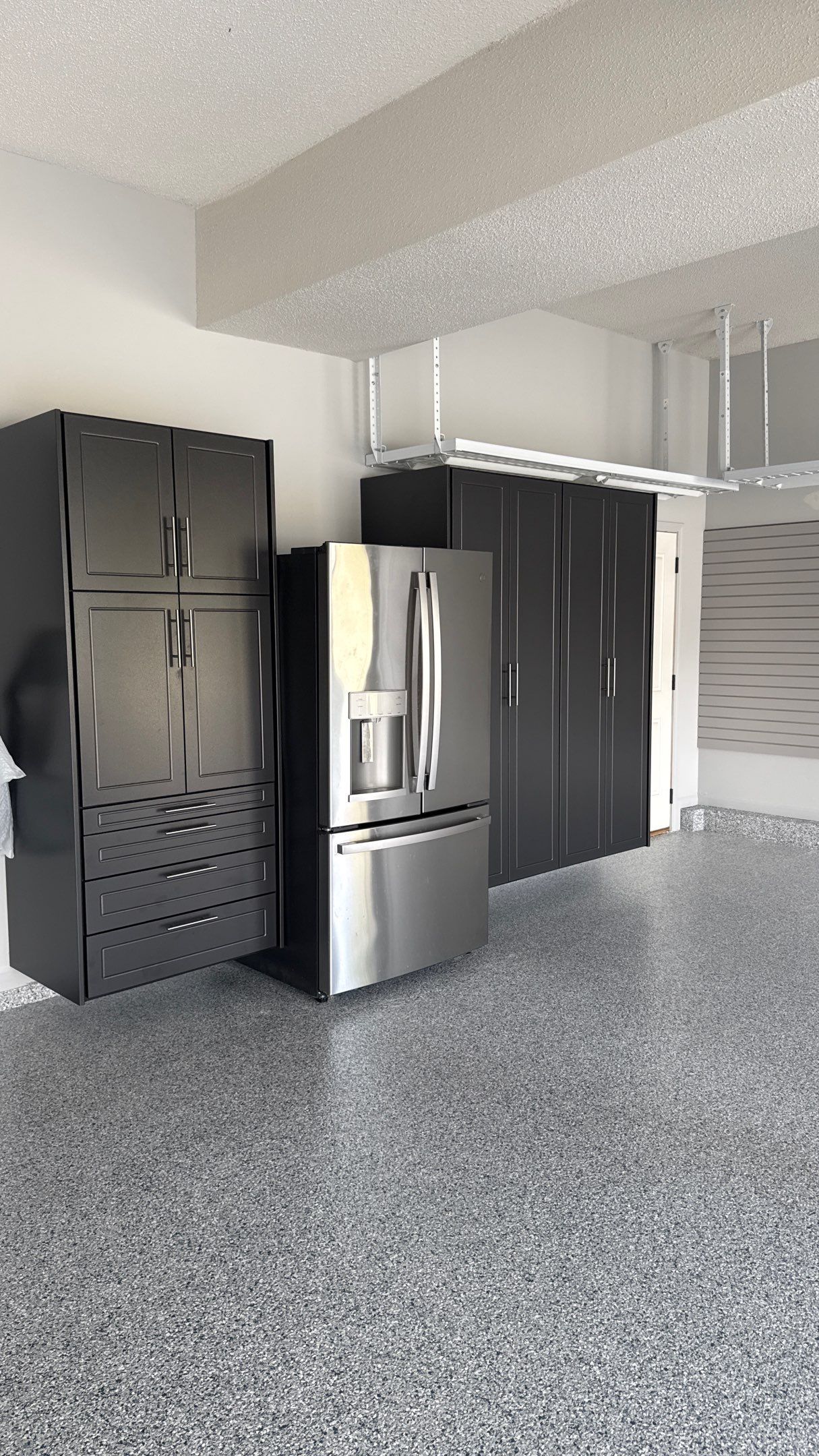 Comprehensive Garage Renovation Featuring Epoxy Flooring and Custom Storage in Shawnee by Banner Garage