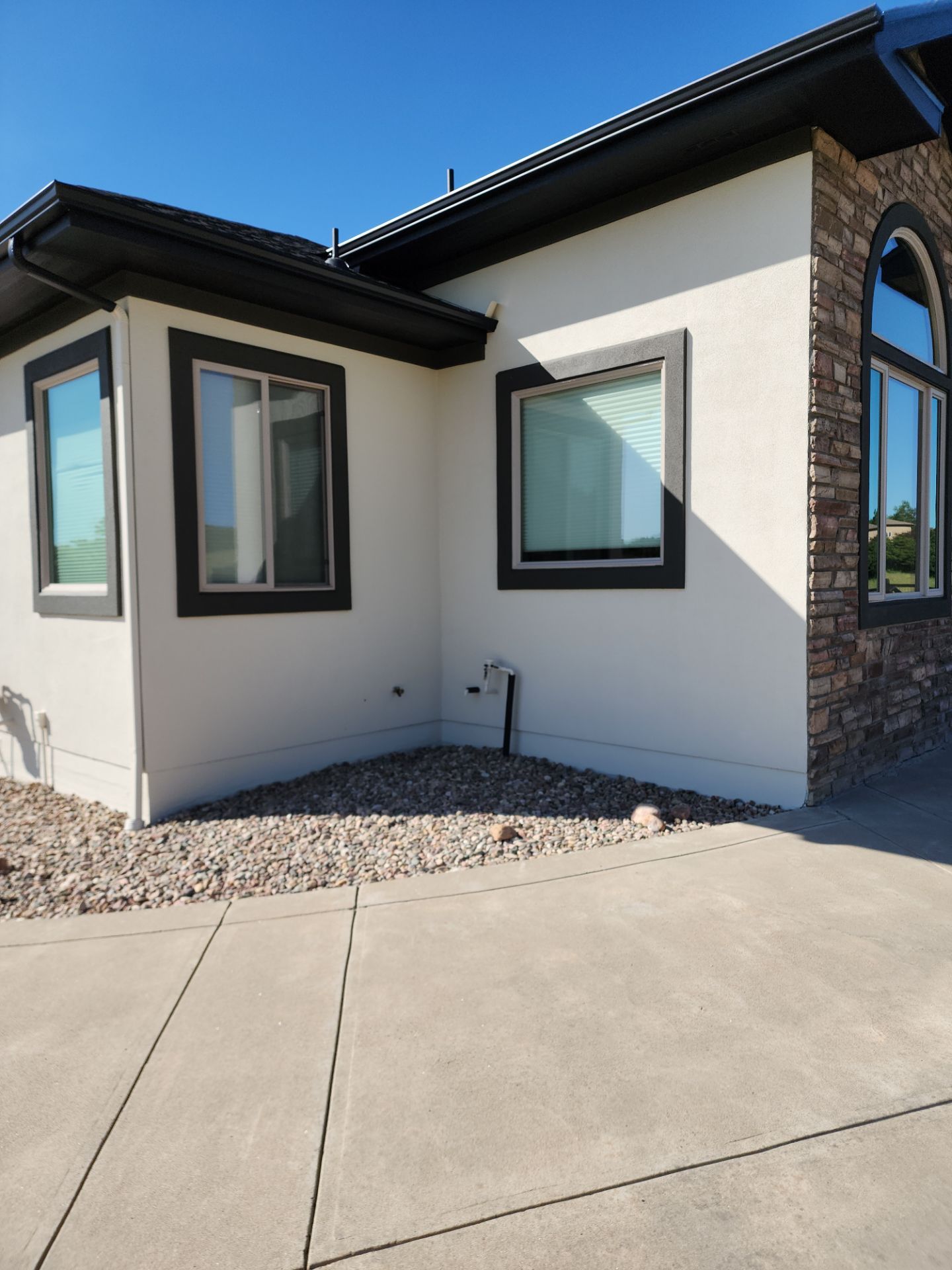 Castle Rock Elegance: White Stucco Exterior with Bold Tricorn Black by J&M Painting LLC