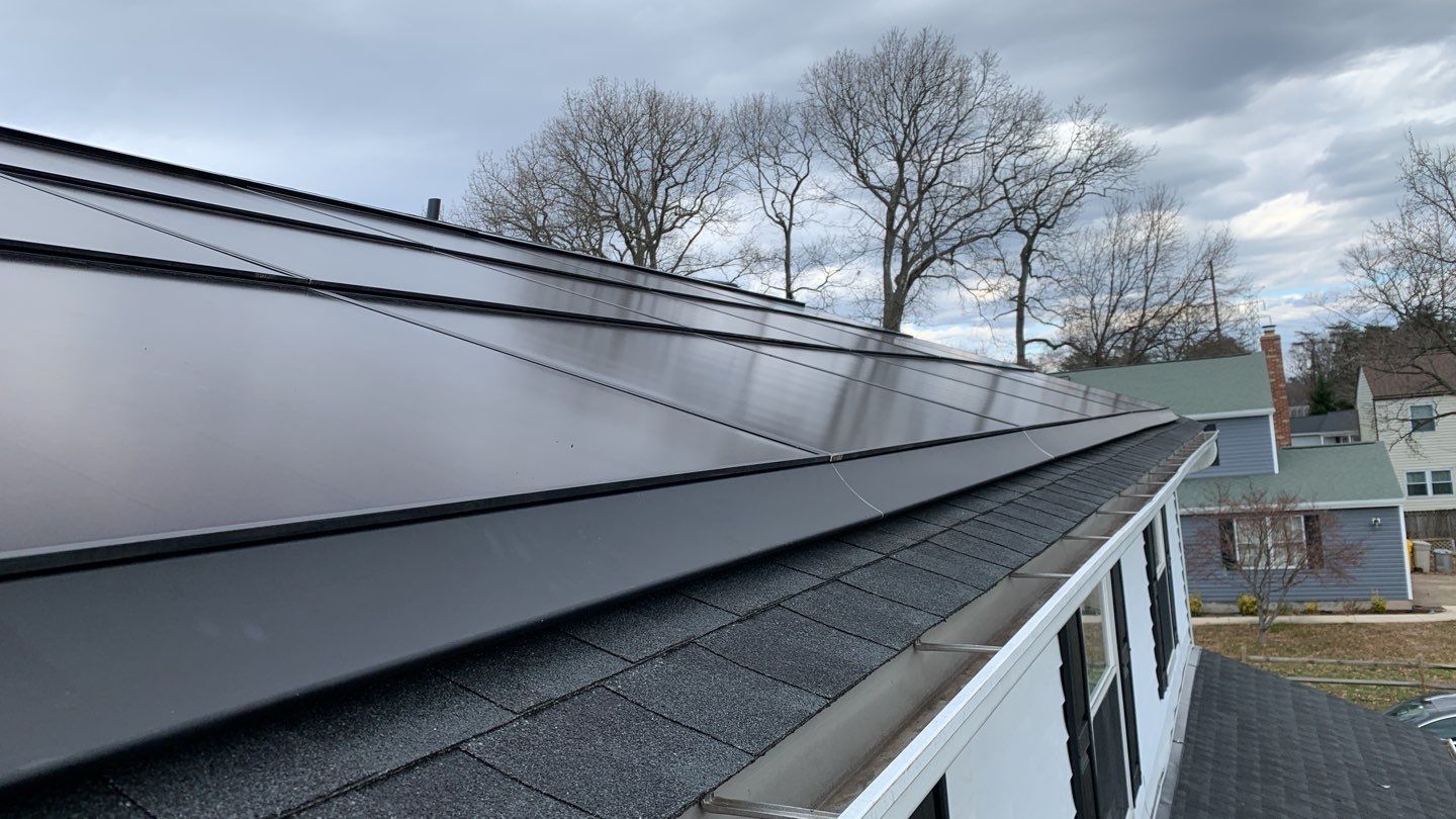 Roof Replacement with GAF Decotech integrated solar panels by American Home Contractors