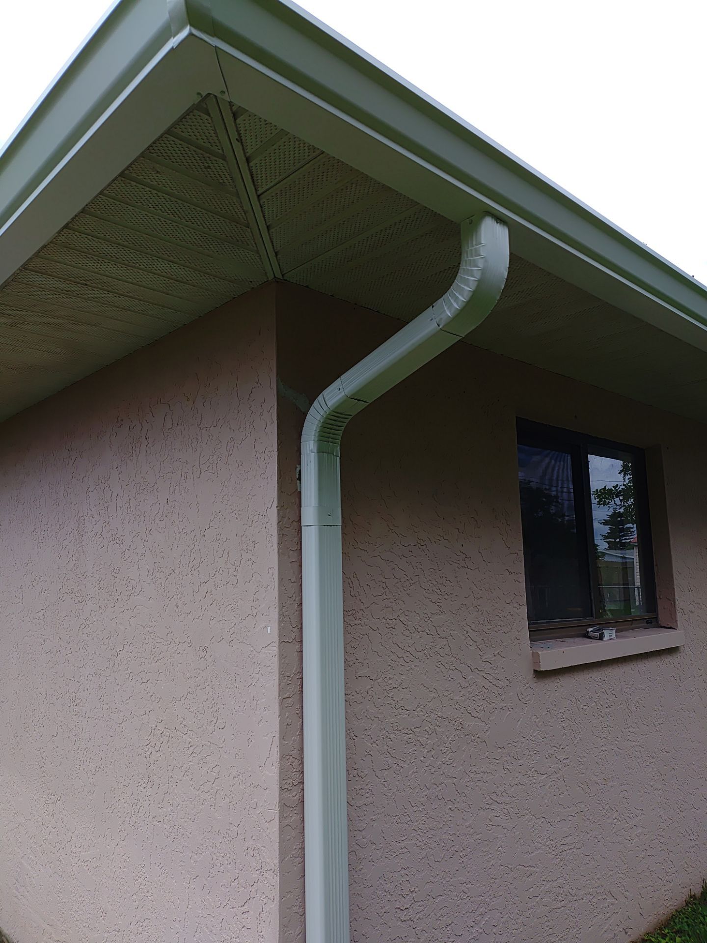 Replace gutter using White Down Spouts in Cape Coral FL by Gutter Professors