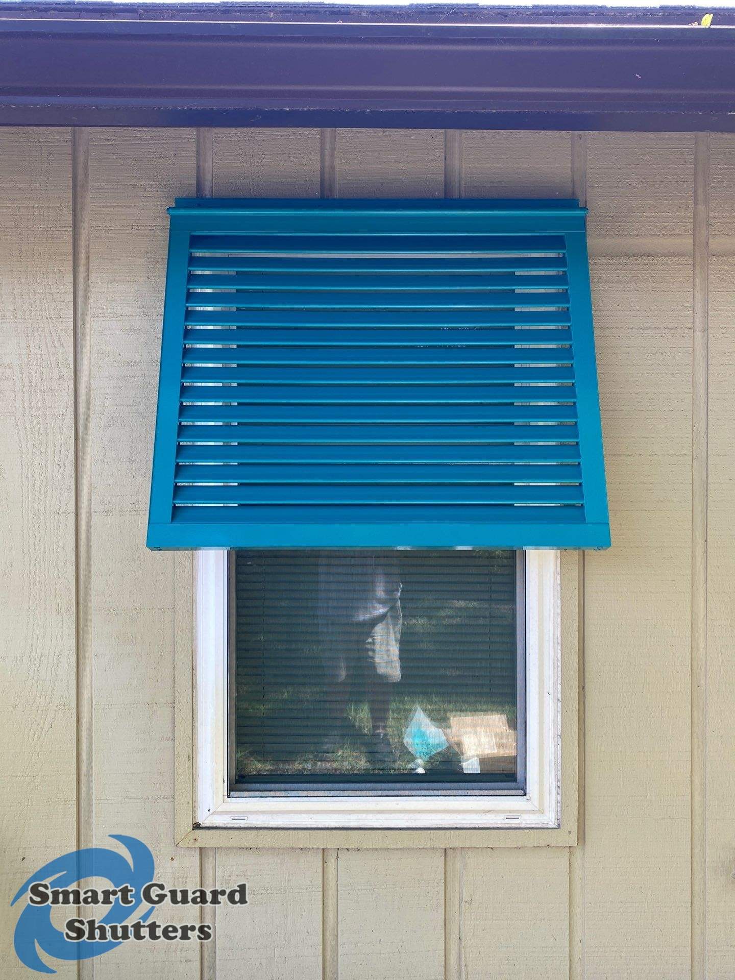 Decorative Bahama Shutters in Turquoise Blue  by Smart Guard Shutters