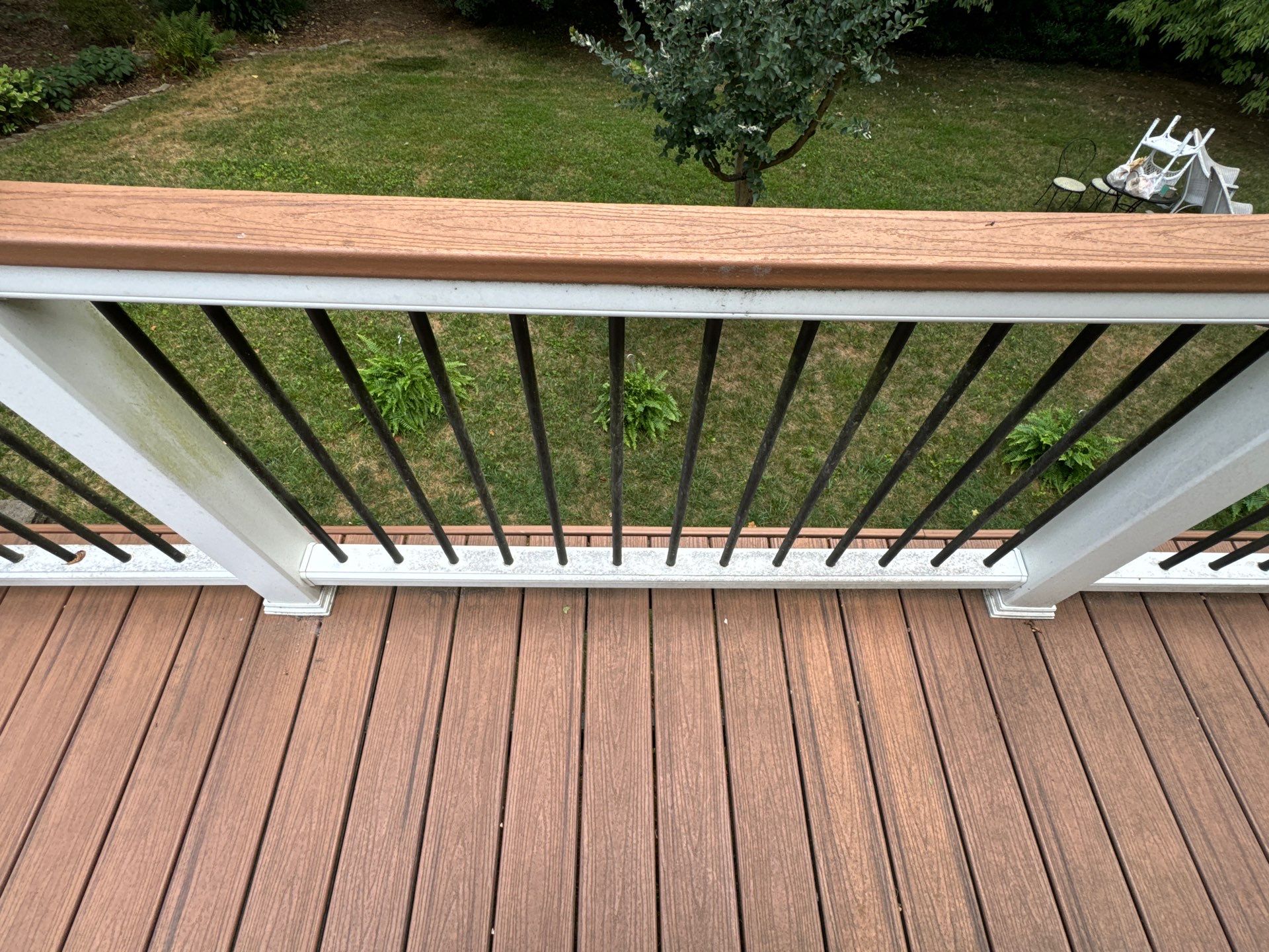 pressure washing company cleaning a wooden deck and railing in winston salem nc