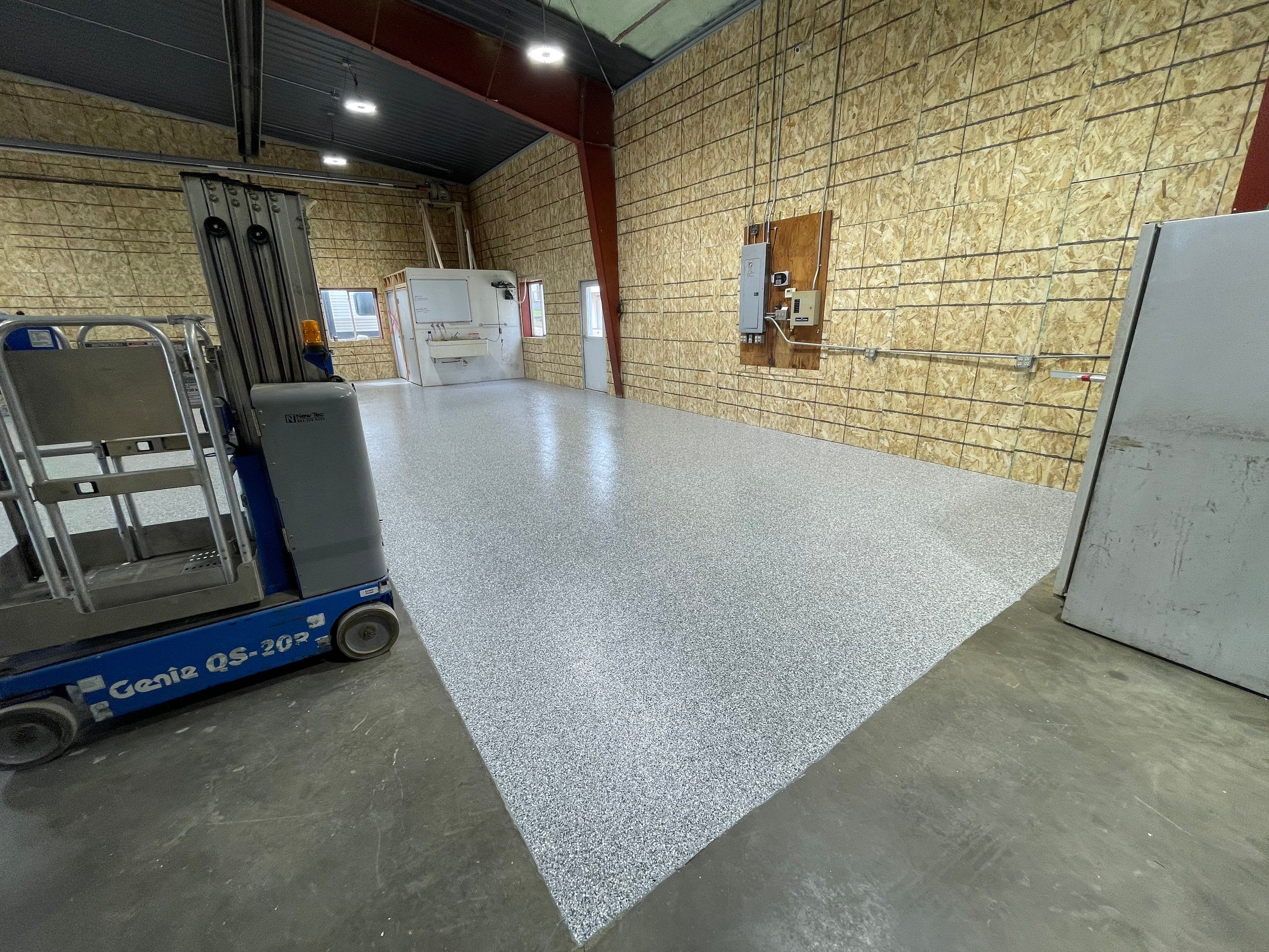 Custom Polyurea Shop Floor with Basketball Court Lines in Rock Valley by Select Painting, Coatings & Garage Cabinets