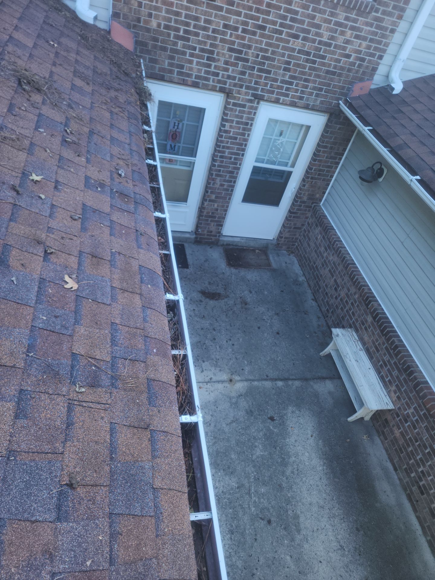 Commercial gutter cleaning Outer Banks & Kill Devil Hills before photo with filled gutters