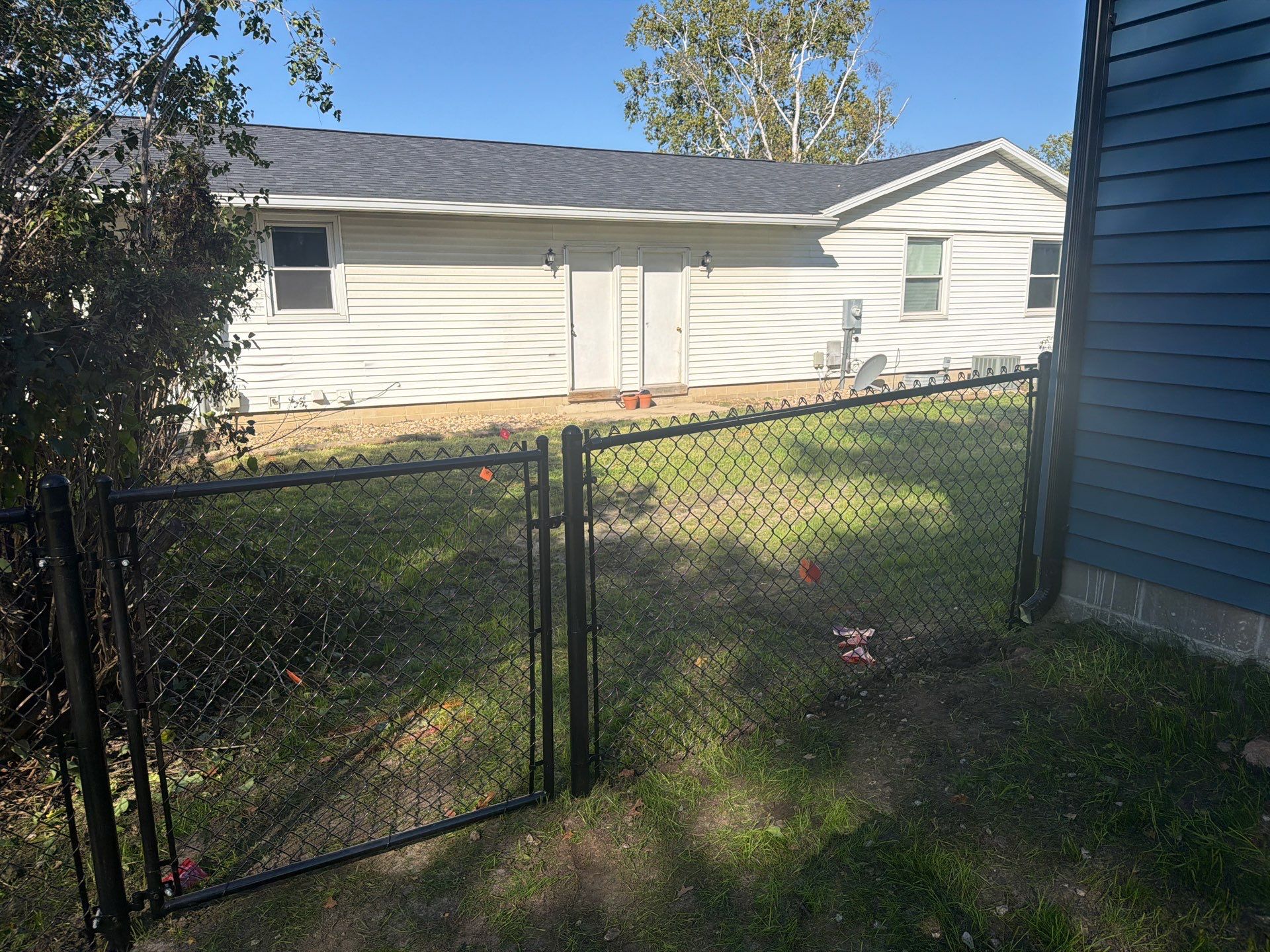 Black Chain Link Fence Installation with Double Gate in Cedar Falls by Perfect Picket Fence and Stain