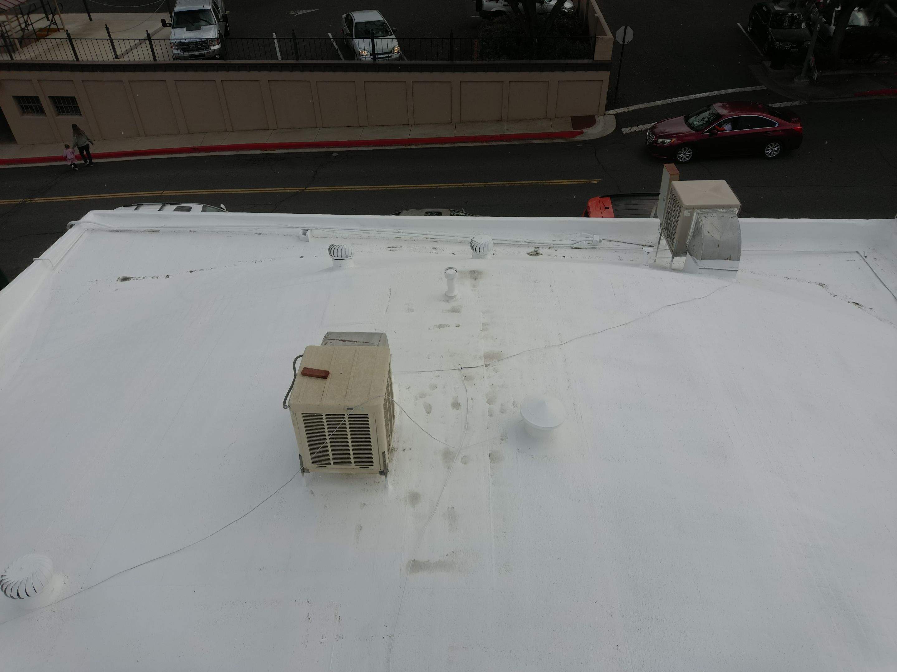 Foam and coatings on commercial roof by Straight Edge Roofing Inc