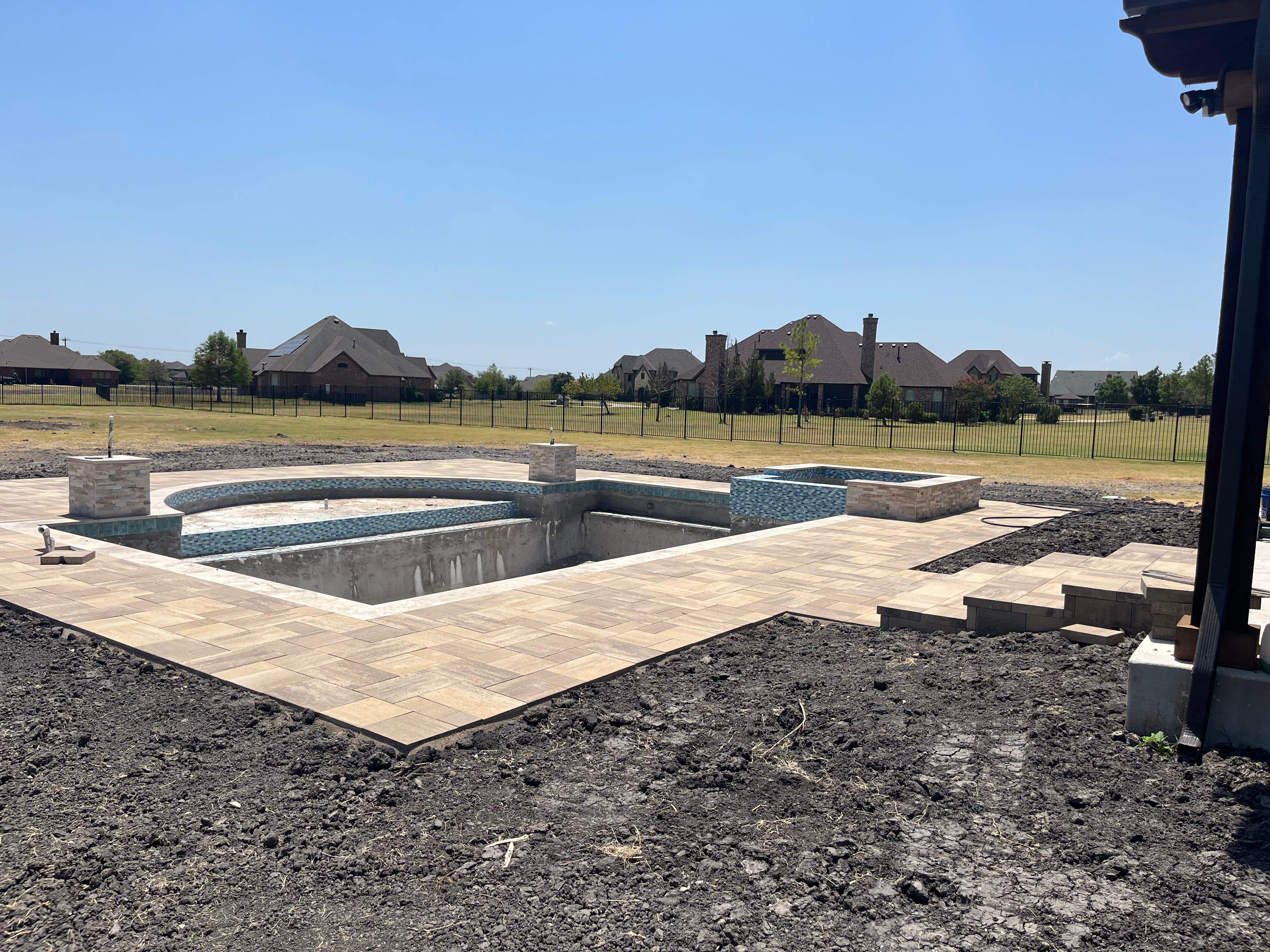 Freeform Pool and Spa with Travertine Decking and Bubblers by Pinnacle Pools and Spas - DFW