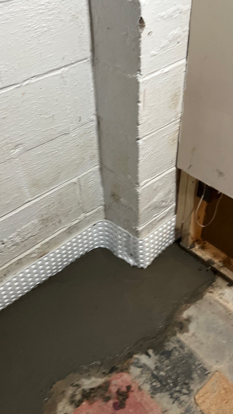 Interior drain tile system installation by ACE Waterproofing & Basement Solutions