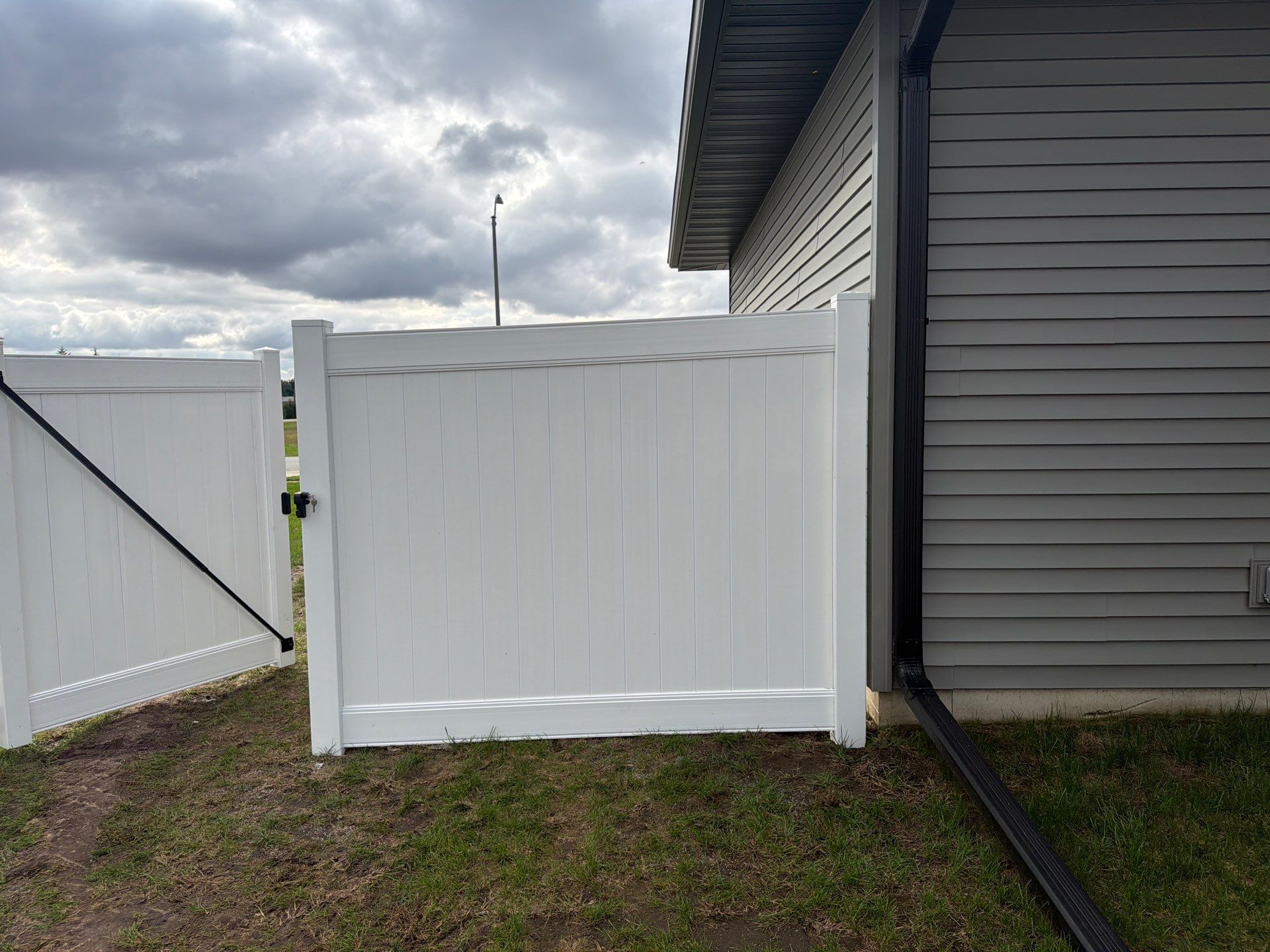 Residential White Vinyl Privacy Fence Installation in Janesville by Perfect Picket Fence and Stain