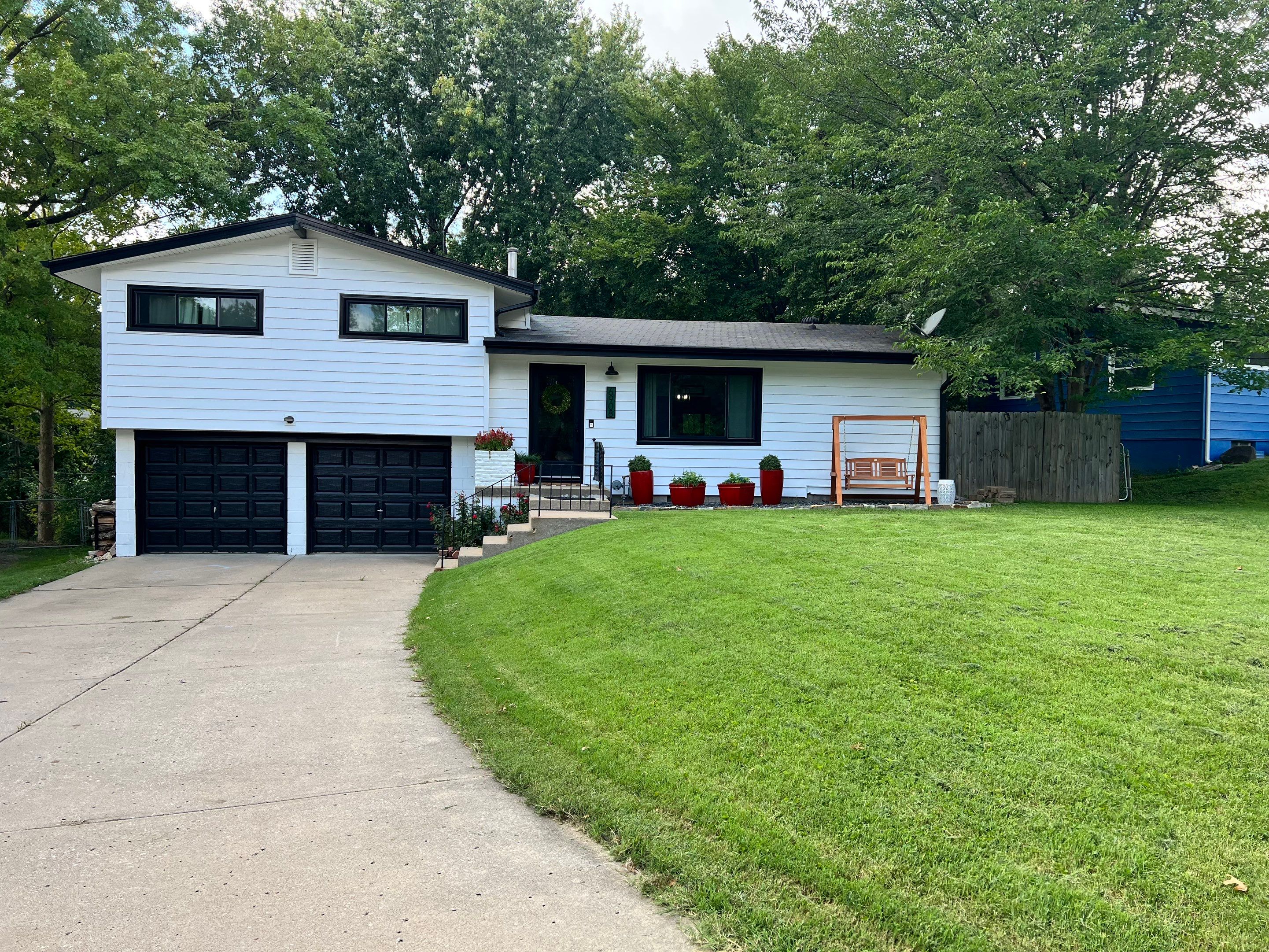 White Craneboard Siding and Heartland Window Installation in Parkville by EEC Windows, Siding & Roofing