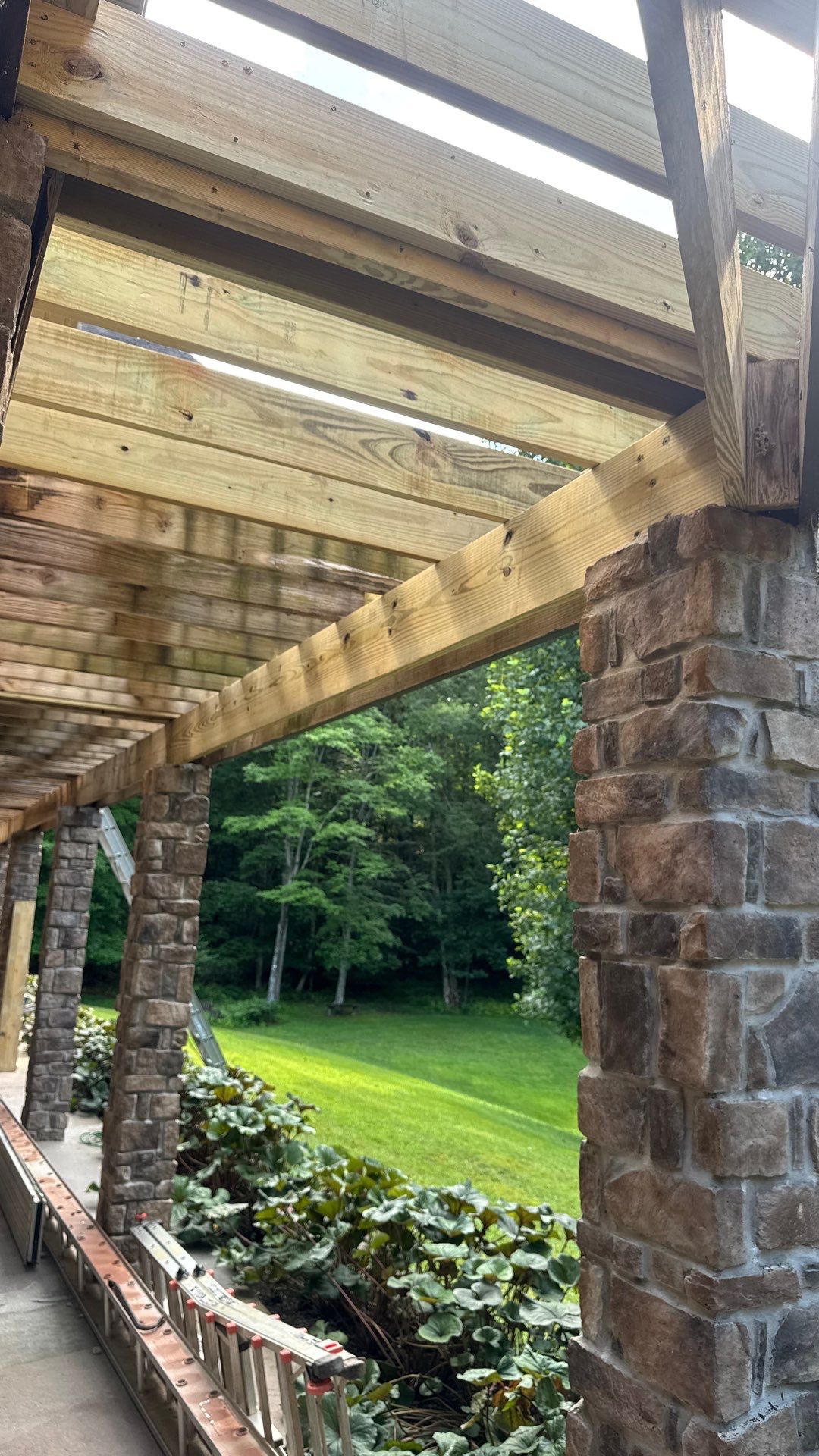 Custom Composite Deck Construction with Stone Pillars in Fayetteville by Walnut Hollow Decks & Outdoor Living