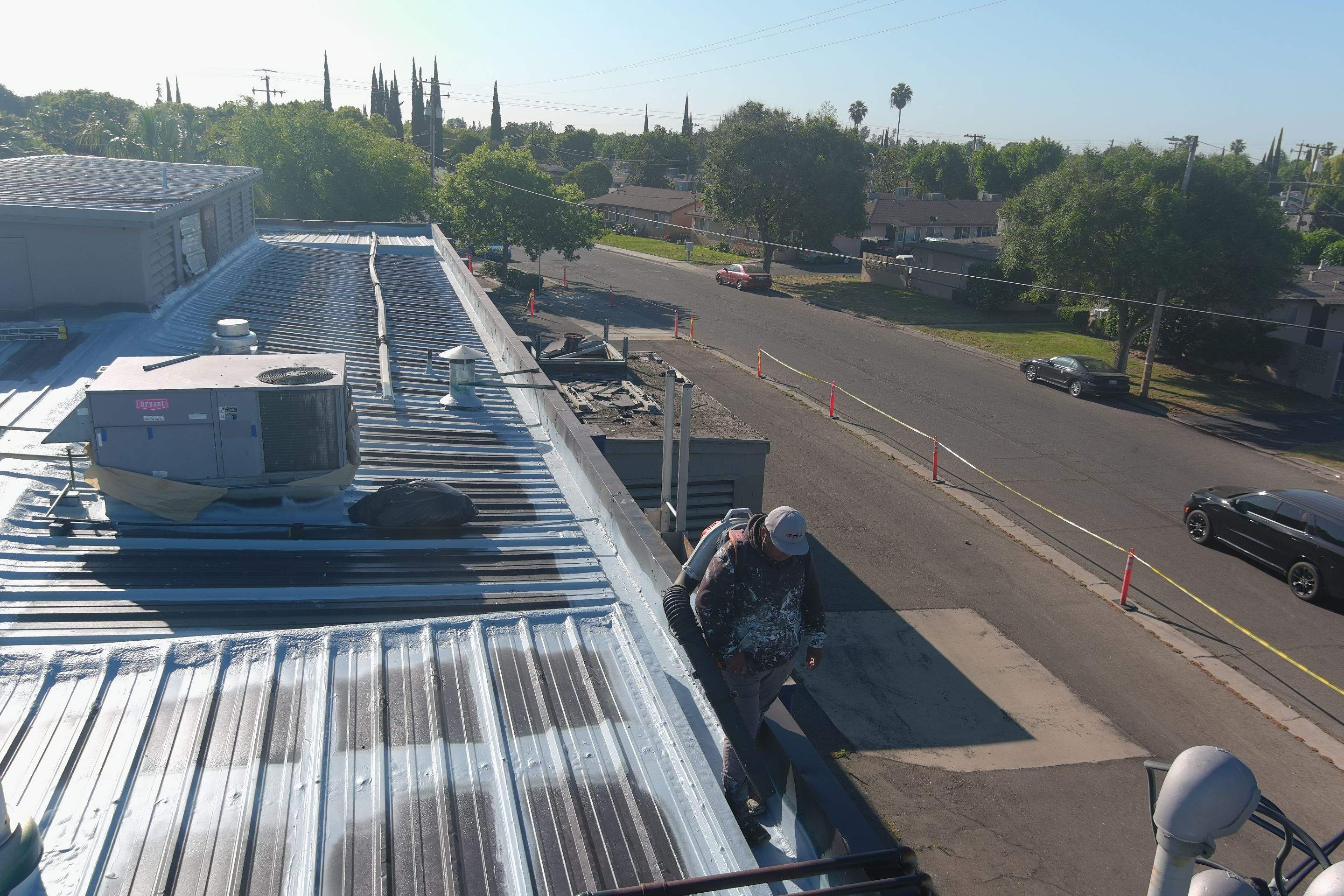 Metal roof restoration on commercial roof using Conklin Benchmark/ PUMA XL acrylic coatings over metal and foam by Straight Edge Roofing Inc