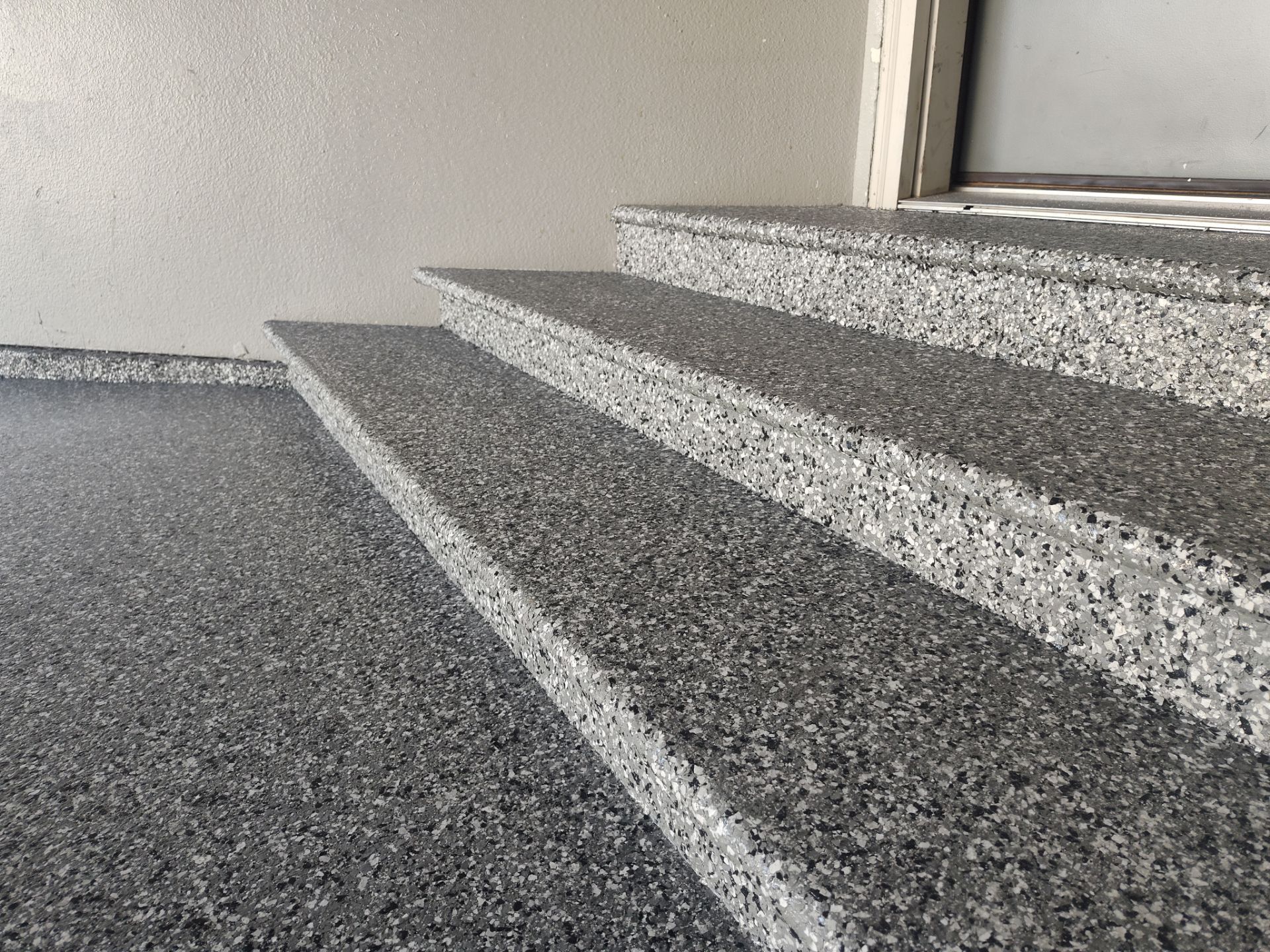 Close Up View of This Customer's New Flake Coating by Revival Concrete Coatings