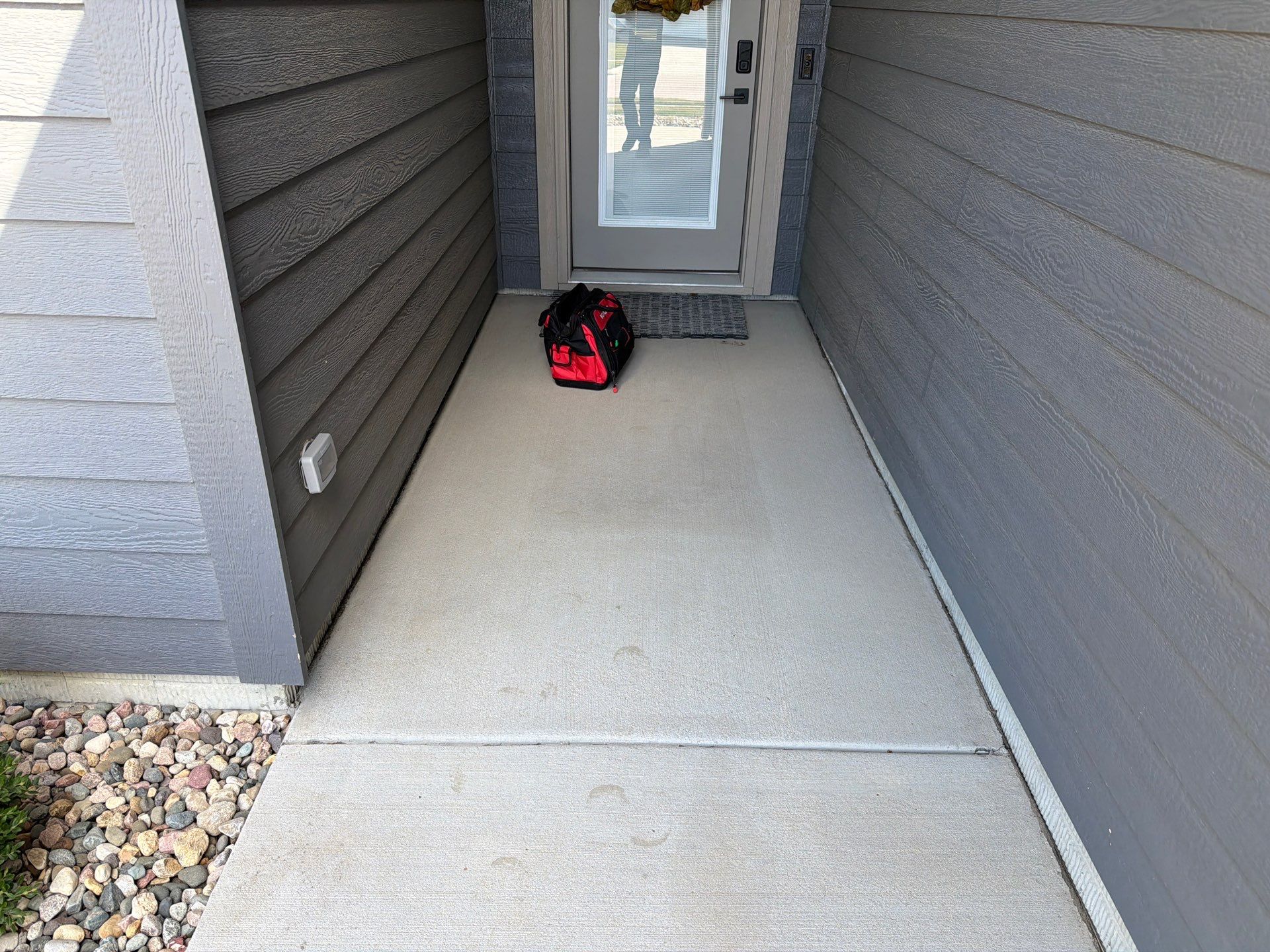 Textured Concrete Patio Coating and Custom Privacy Pergola in Sioux Falls by Select Painting, Coatings & Garage Cabinets