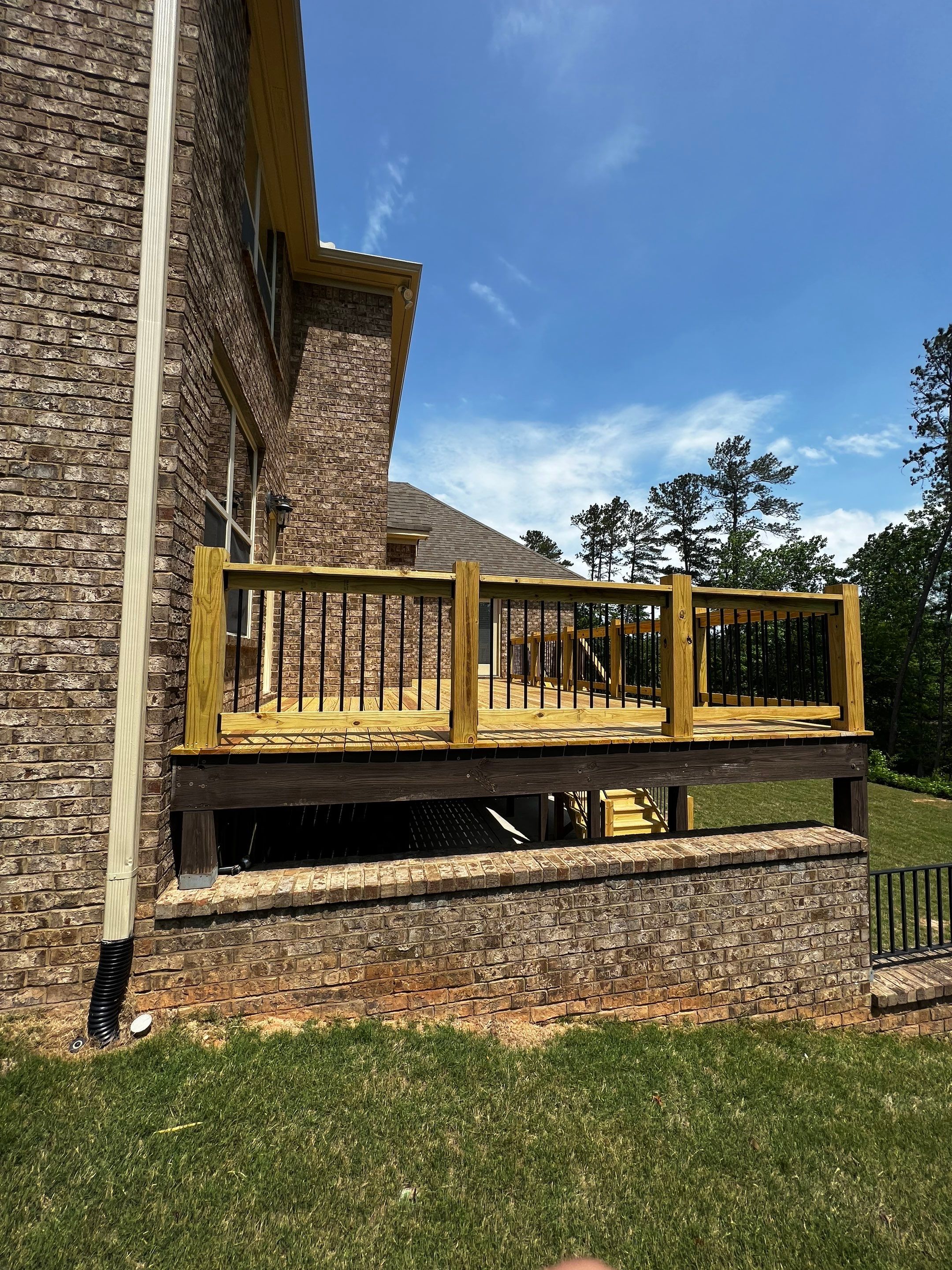 Elevated Pressure-Treated Wood Deck and Staircase in Hampton by Swift Home Renovations