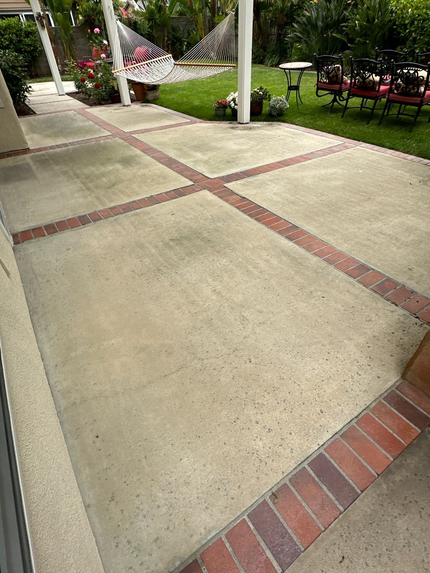Surface cleaning pressure washing in Orange County on patio, walkways, and driveway by Property Cleaning Experts, LLC