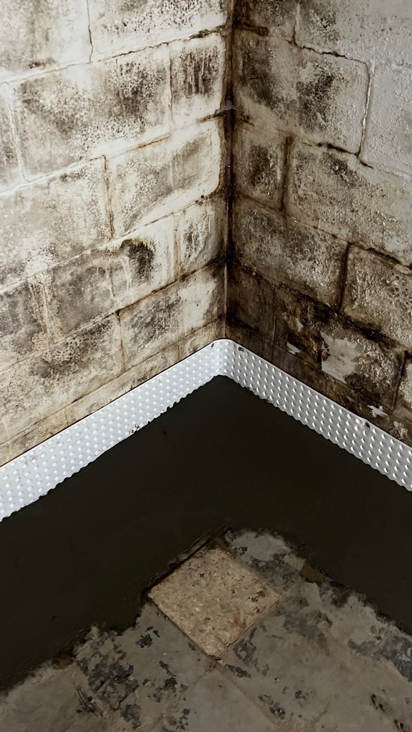 Interior drain tile system installation by ACE Waterproofing & Basement Solutions
