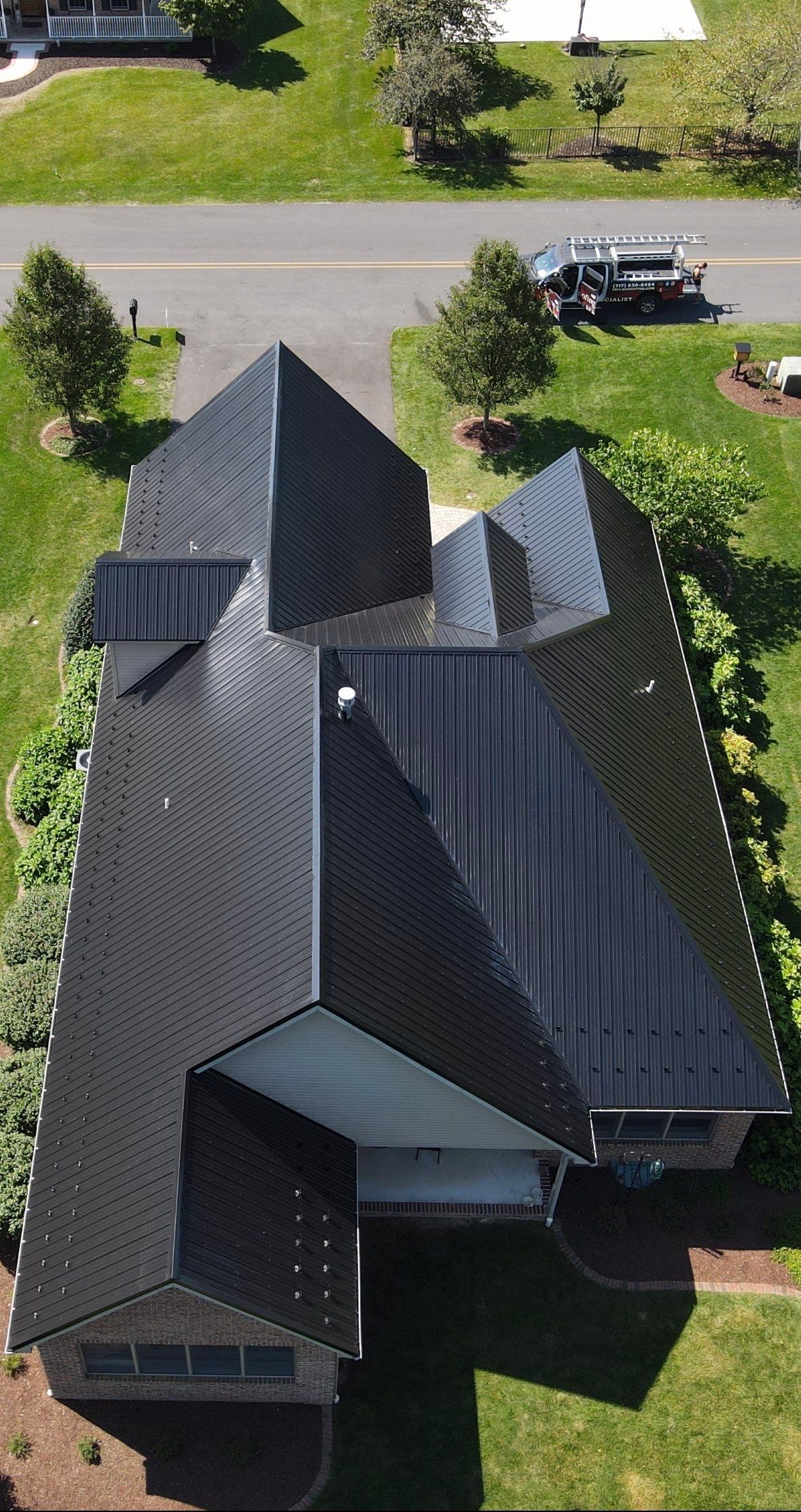 Standing seam / Azm panel in black  by Teflon Roofing