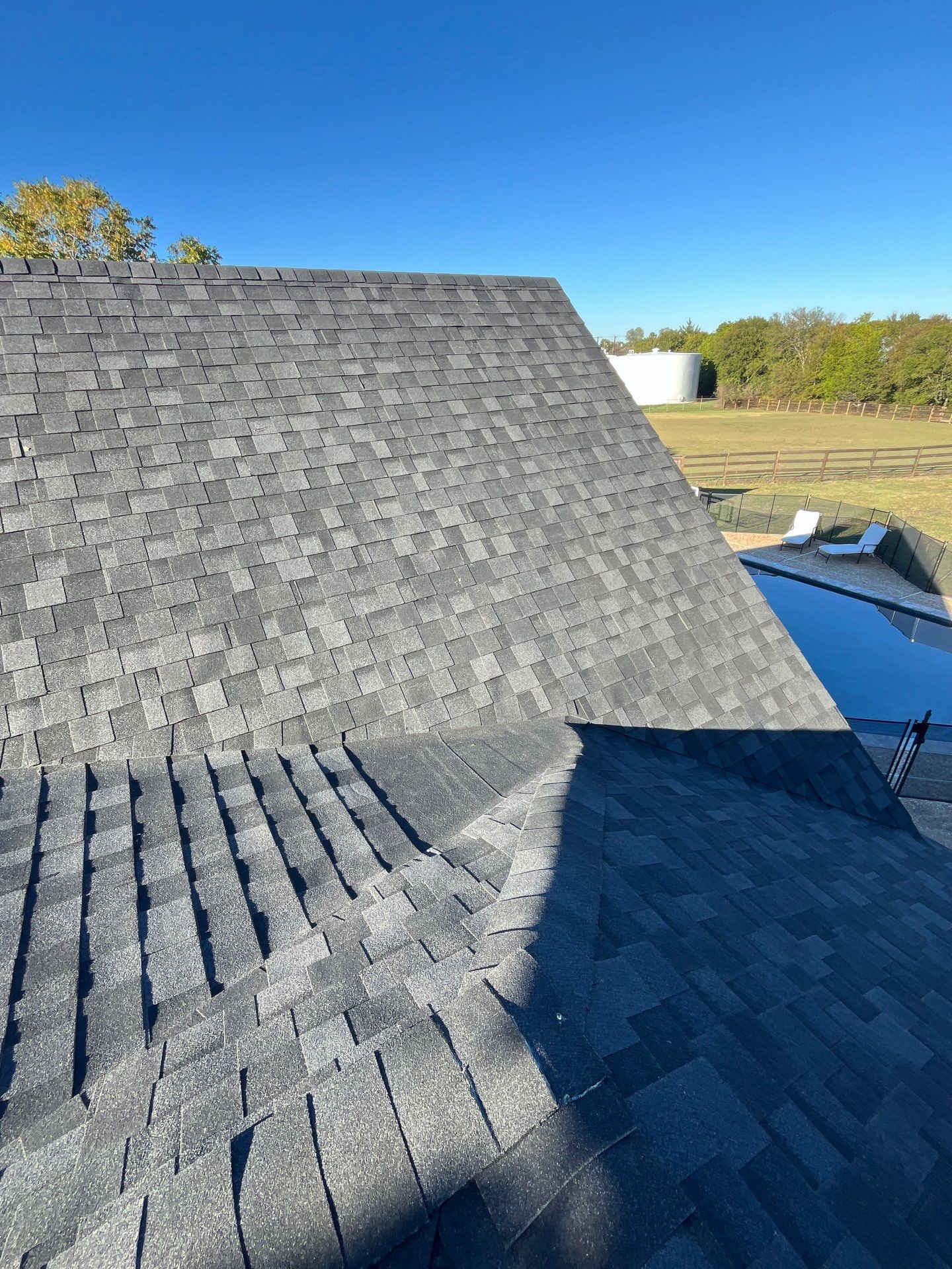 White brick with IKO Granite Black by Tejas Roofworks + Restoration