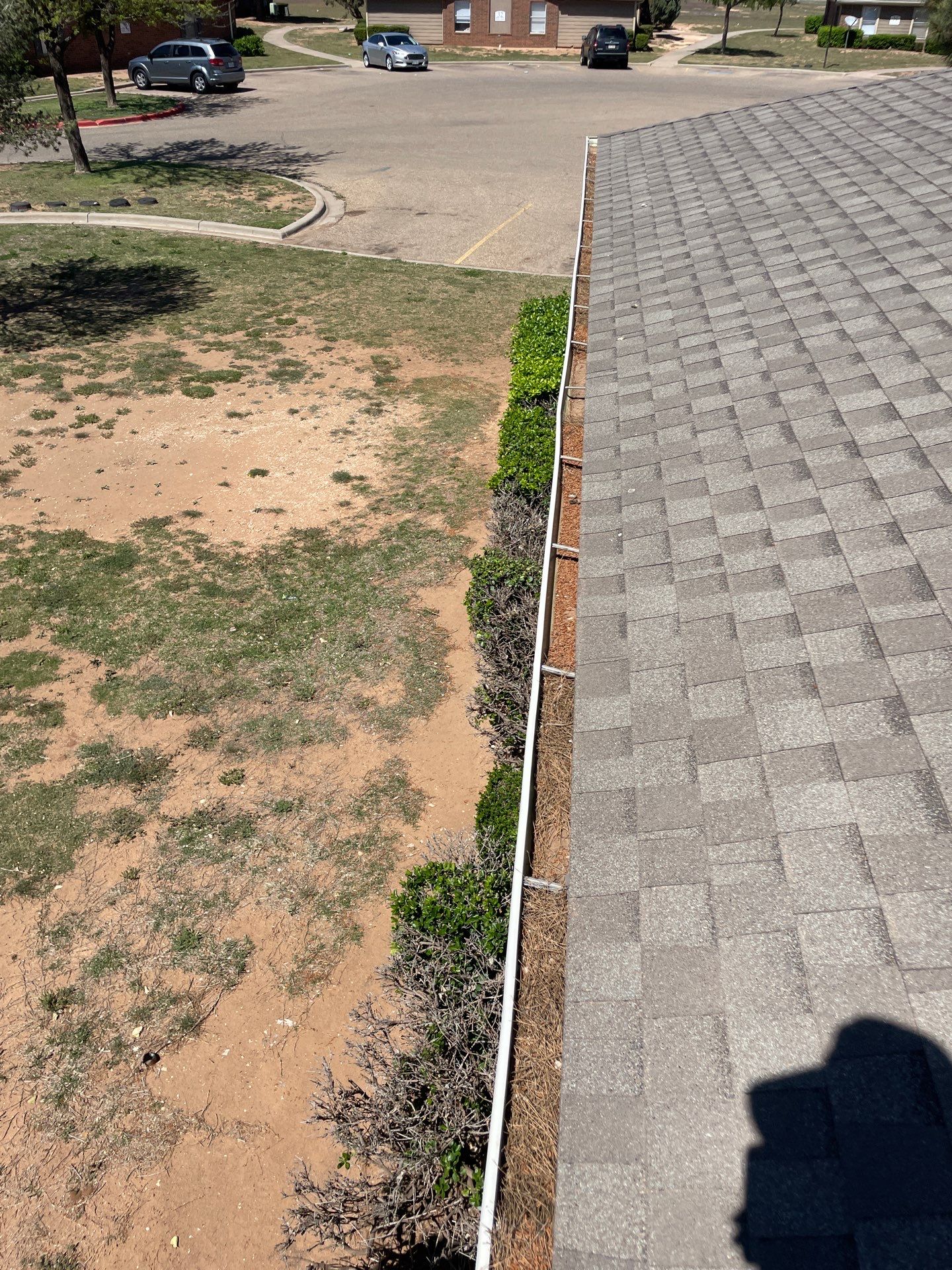 Commercial gutter cleaning Amarillo, TX before photo with filled gutters