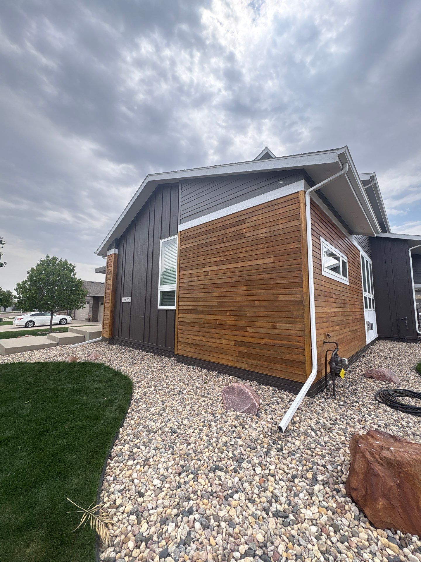 Modern Exterior Transformation Featuring Dark Board and Batten Siding in Sioux Falls by Select Painting, Coatings & Garage Cabinets