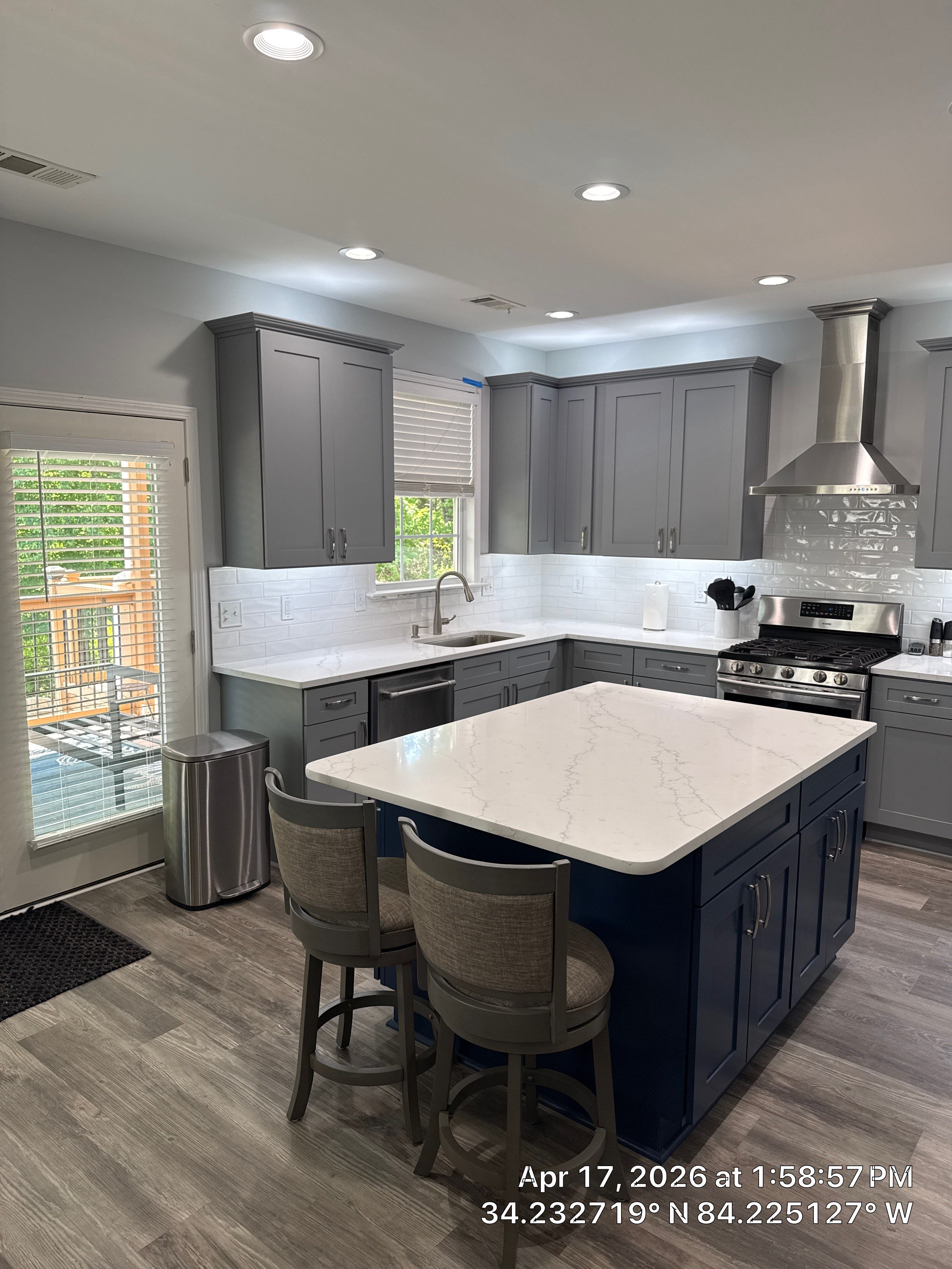 Modern Kitchen Remodel With Grey Shaker Cabinets and Navy Blue Island