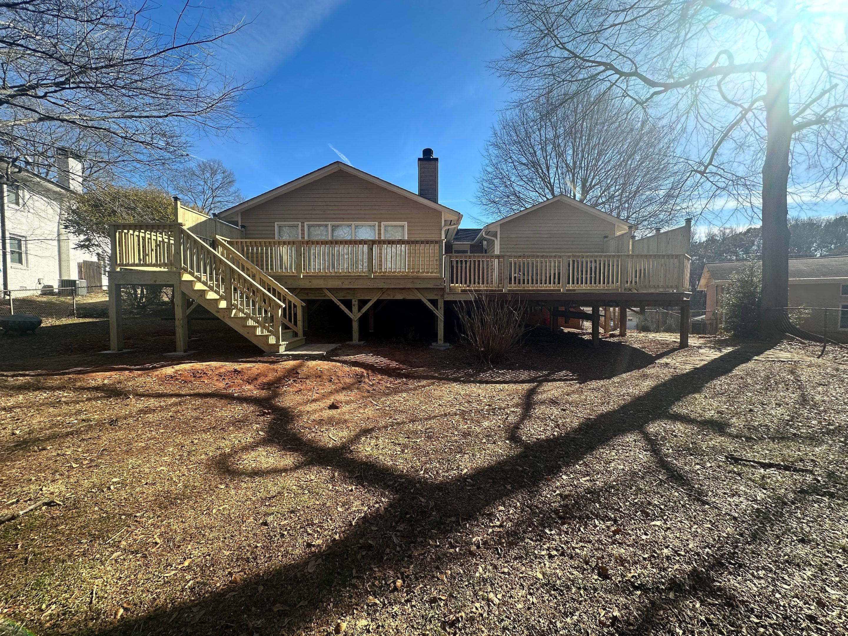 Elevated Pressure-Treated Wood Deck Extension in Marietta by Swift Home Renovations
