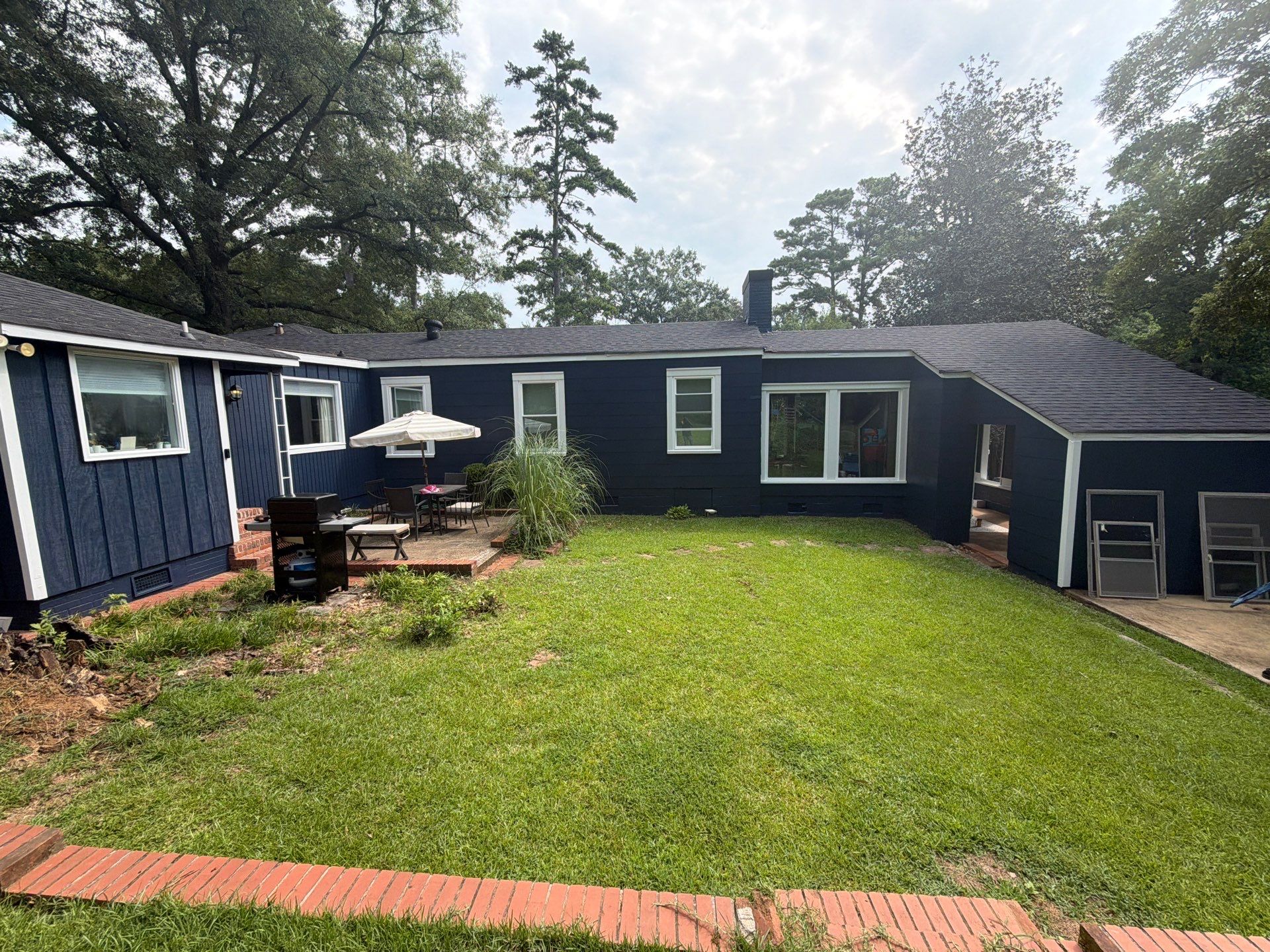 Full Exterior Repaint with Navy Blue and White Trim by Swift Home Renovations