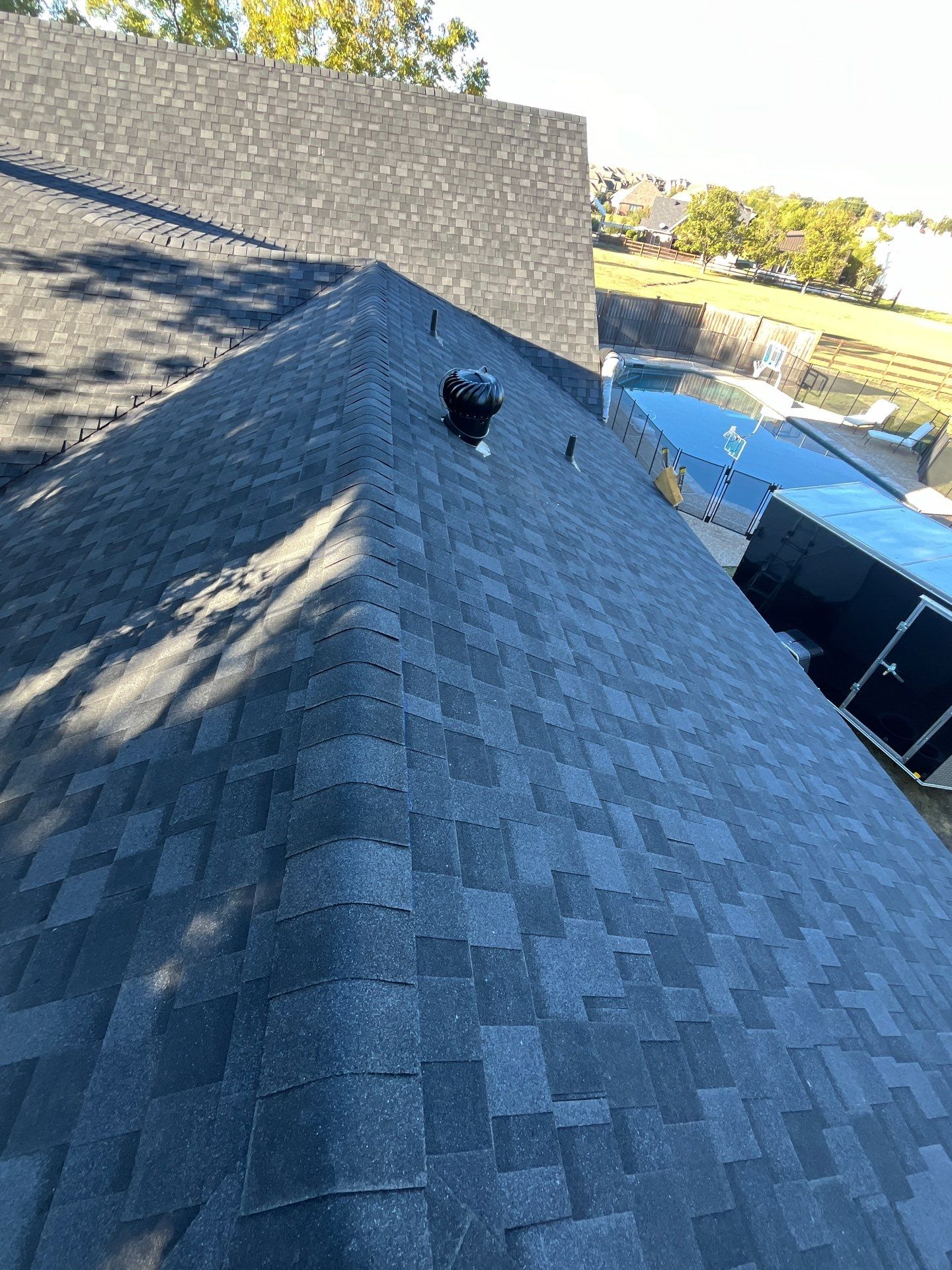 White brick with IKO Granite Black by Tejas Roofworks + Restoration