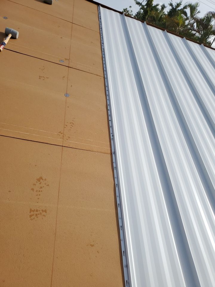 Residential Roofing Installation using 1.5" Nail Strip 24ga Solar White Kynar Coated Standing Seam Metal Panels by Morton Roofing, Inc.
