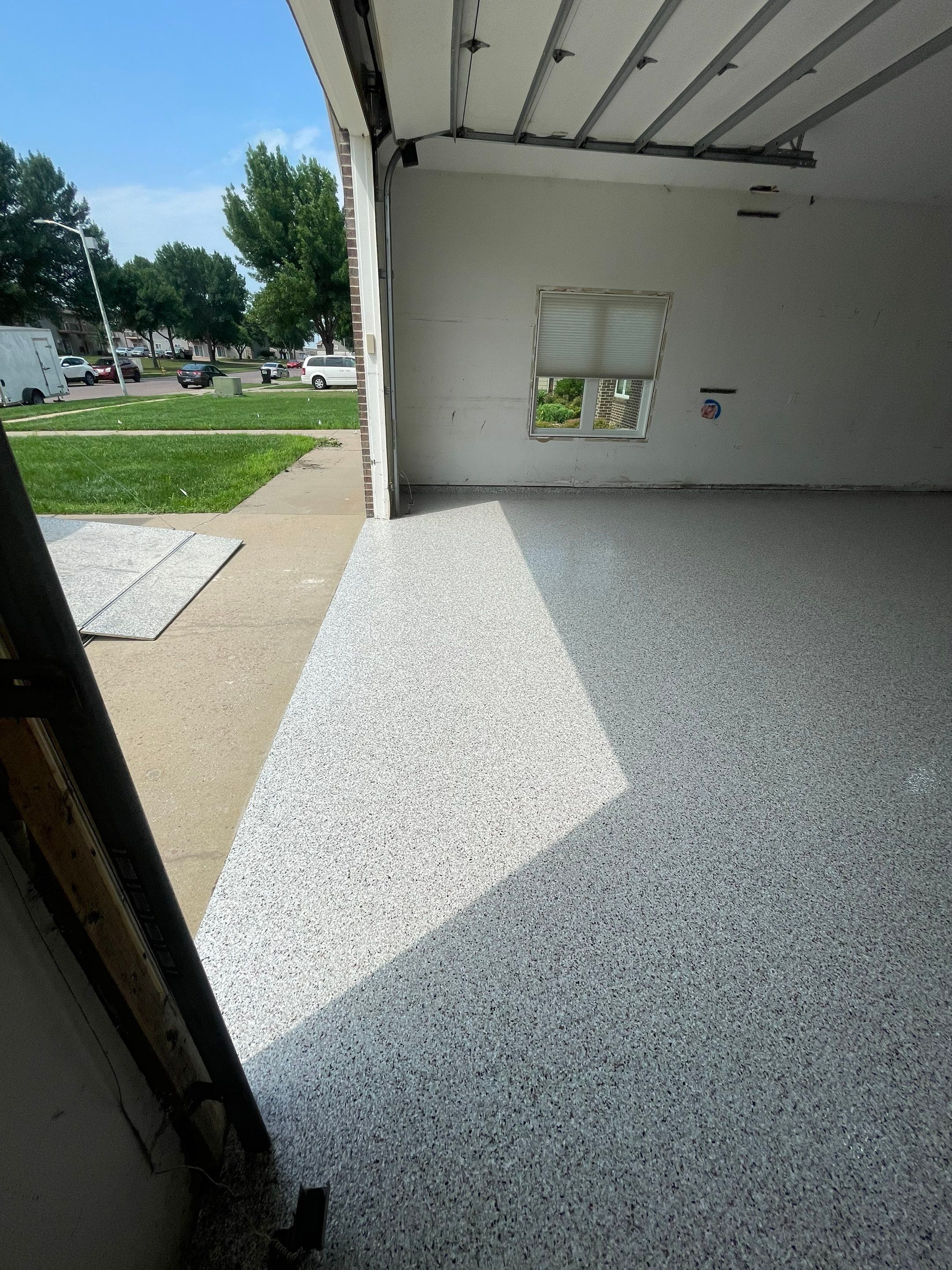 Coyote Flake Concrete Coating for Sioux Falls Garage by Select Painting, Coatings & Garage Cabinets