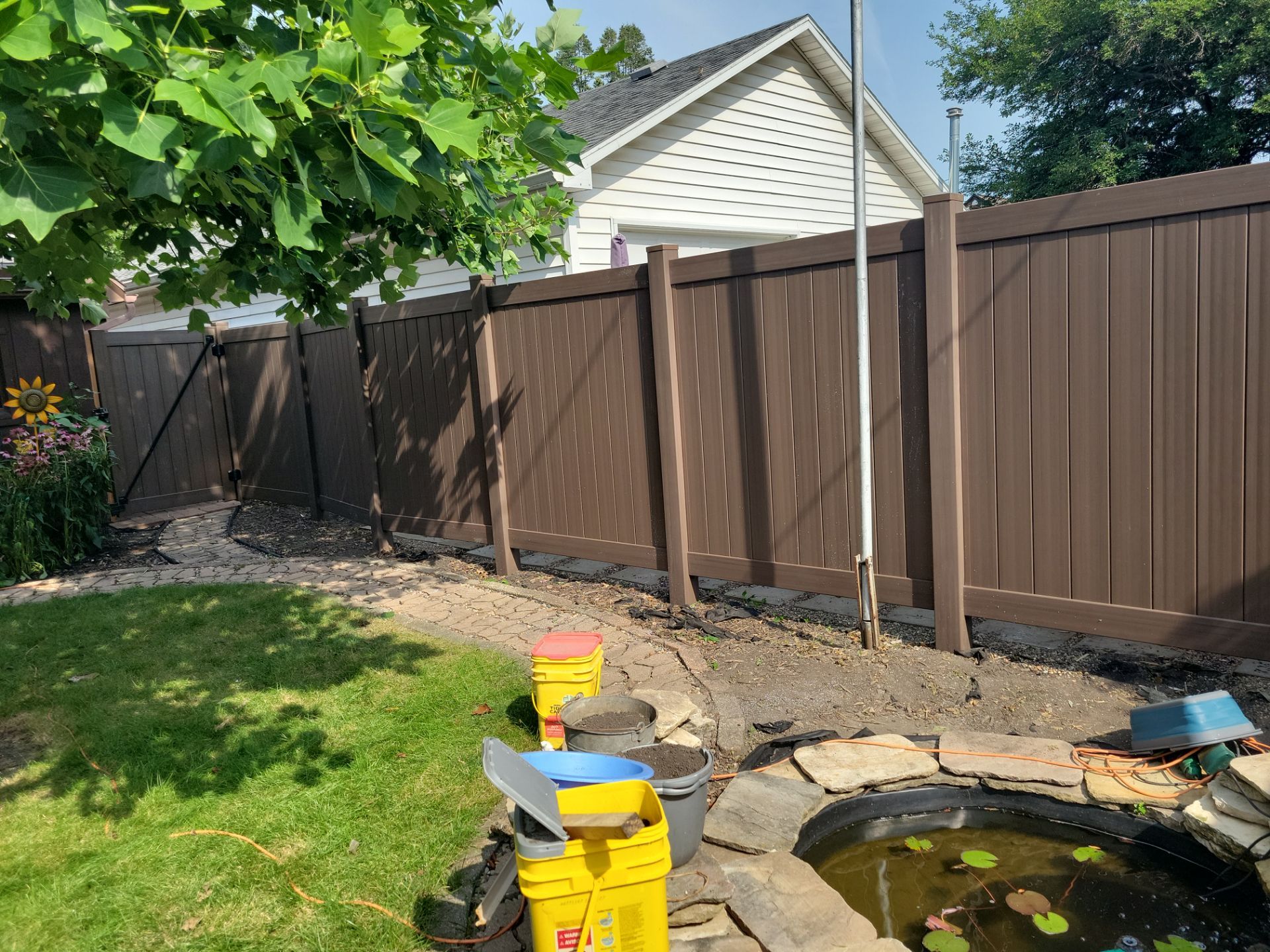 Walnut Vinyl Privacy Fence Installation in Waterloo by Perfect Picket Fence and Stain