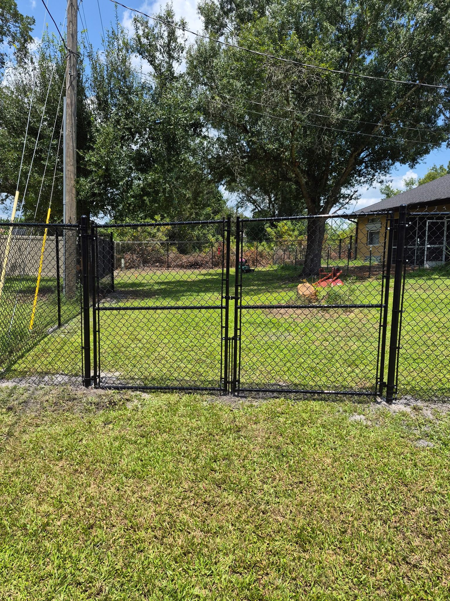 Black Chain Link Perimeter Fencing with Double Gates in Port Charlotte by True Fence LLC