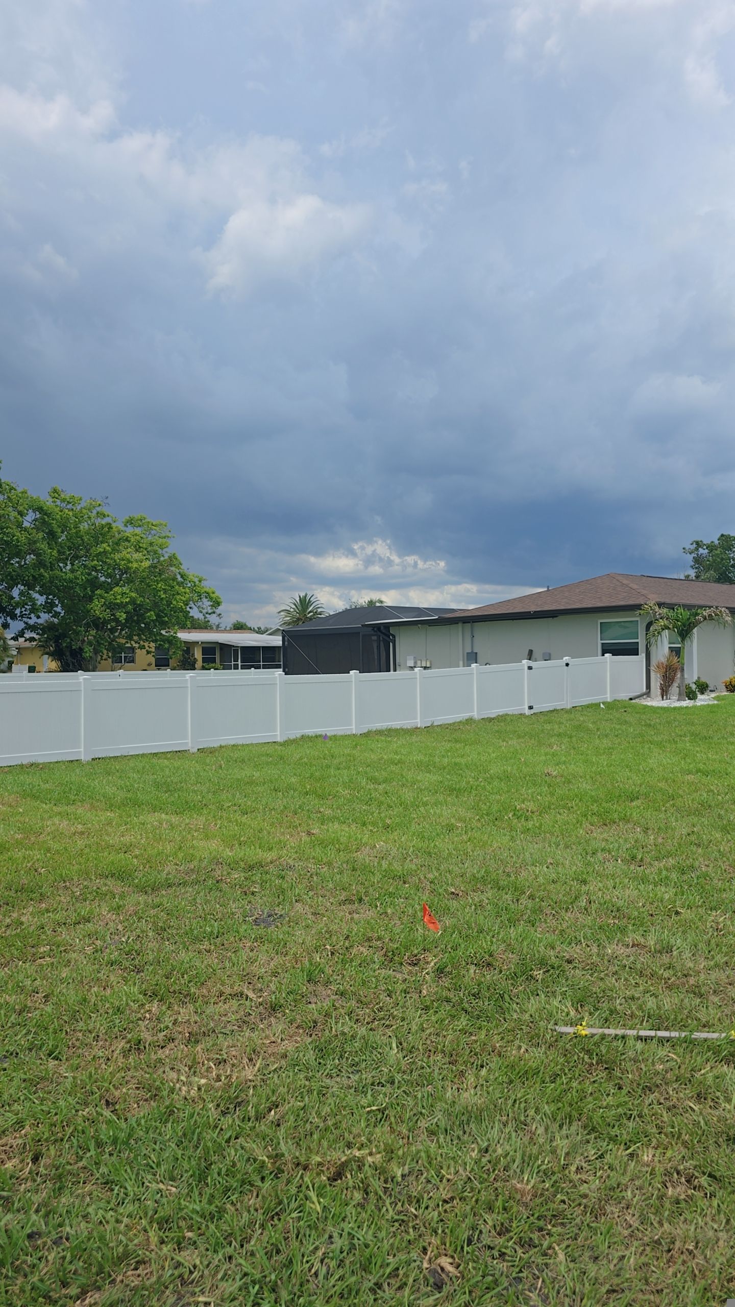 White Vinyl Privacy Fence Installation on Port Charlotte Corner Lot by True Fence LLC