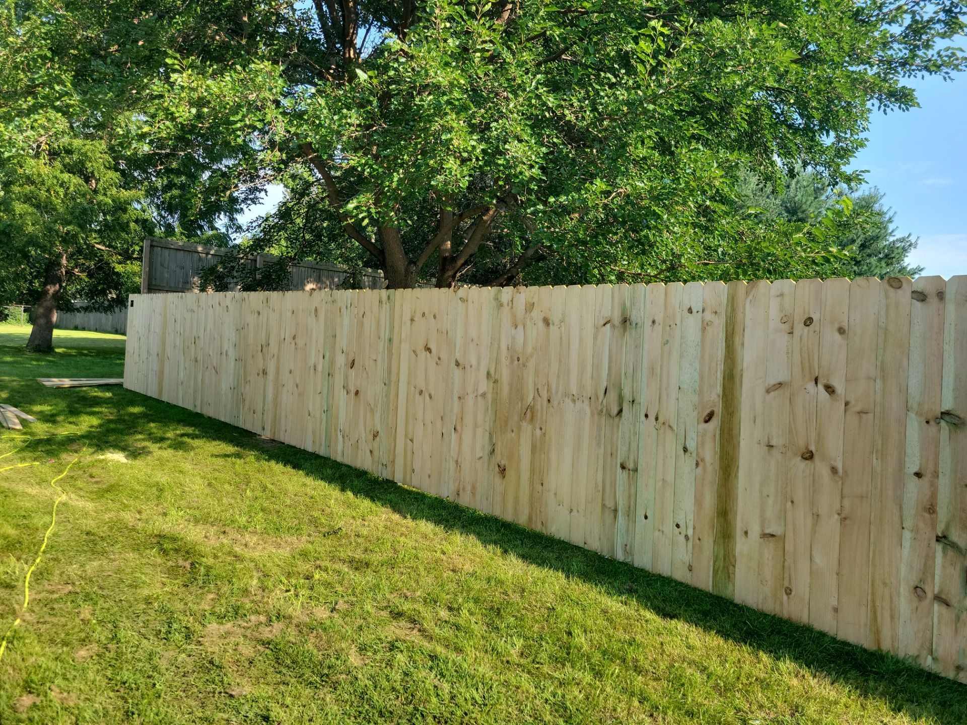 Pressure-Treated Wood Privacy Fence Replacement in Cedar Falls by Perfect Picket Fence and Stain