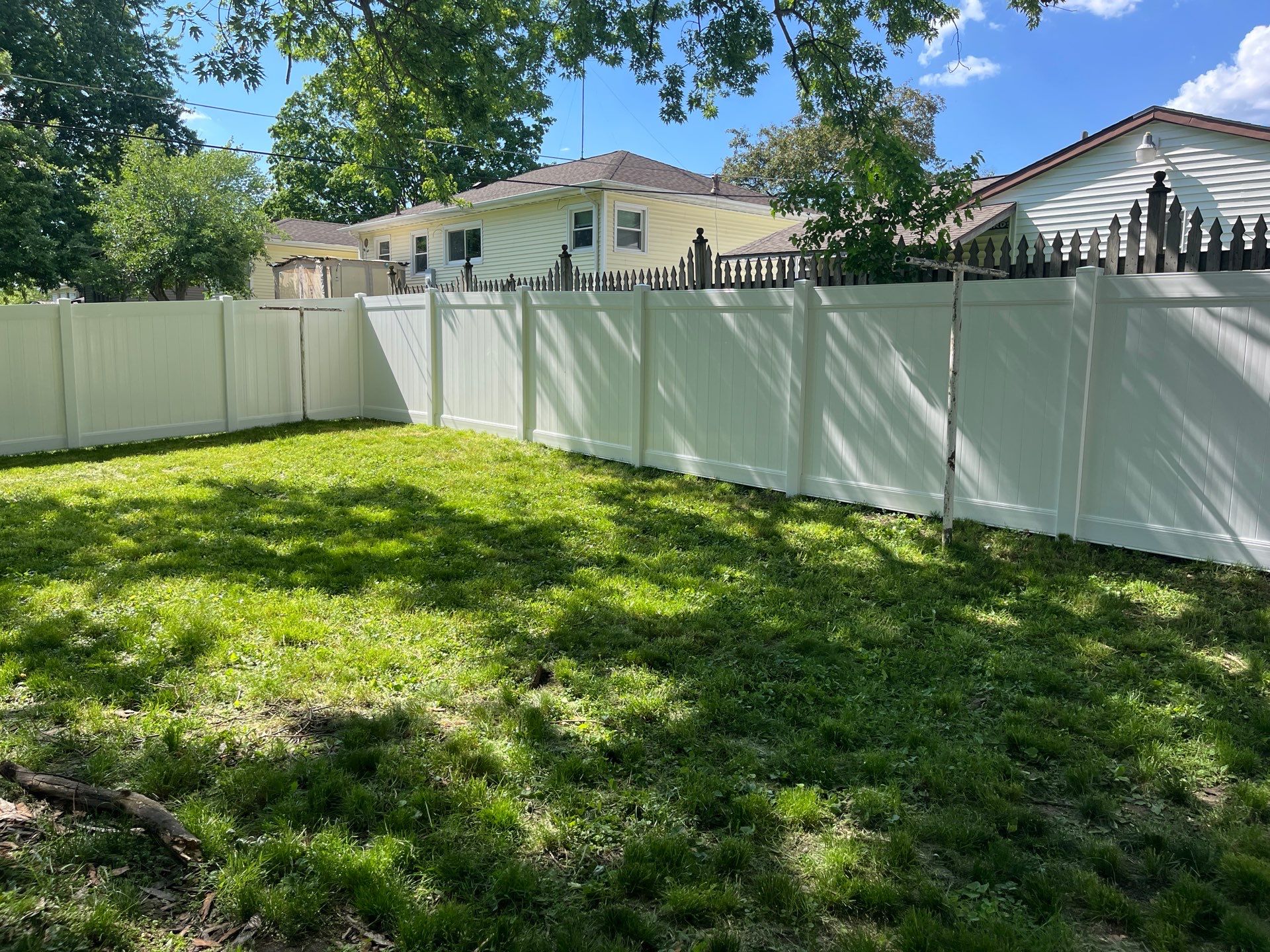 White Vinyl Privacy Fence and Double Gate Installation in Cedar Falls by Perfect Picket Fence and Stain
