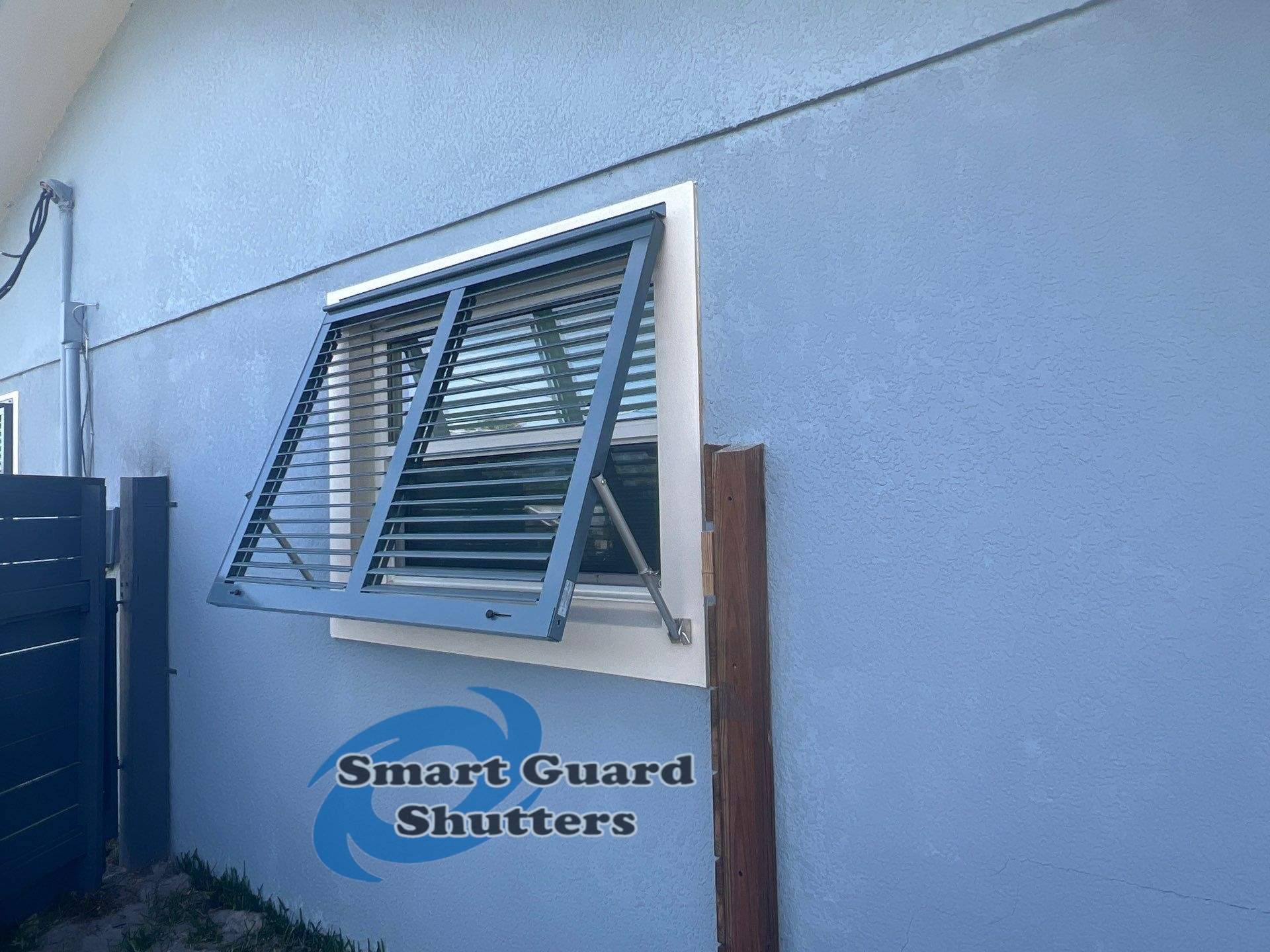 Impact Bahama Shutters in Grey Blue by Smart Guard Shutters