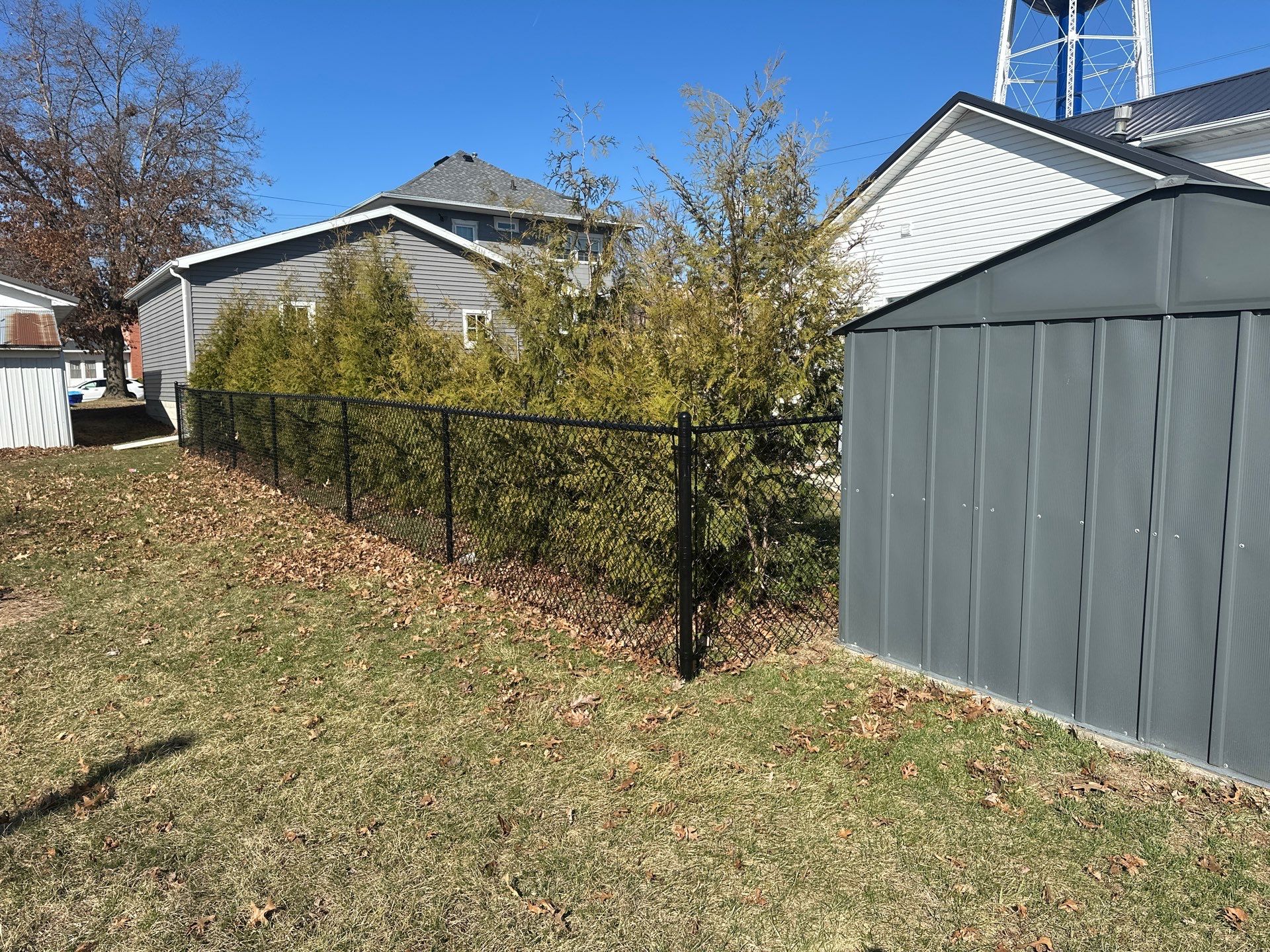 Black Chain Link Backyard Fence Installation in Independence by Perfect Picket Fence and Stain