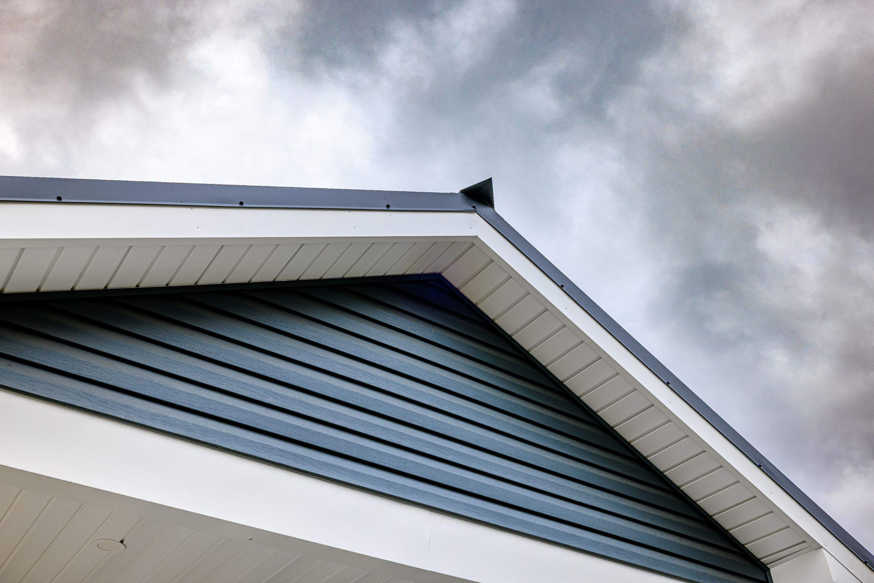 New Residential Addition with Blue Siding and Metal Roofing in Ashland by Esh Builders