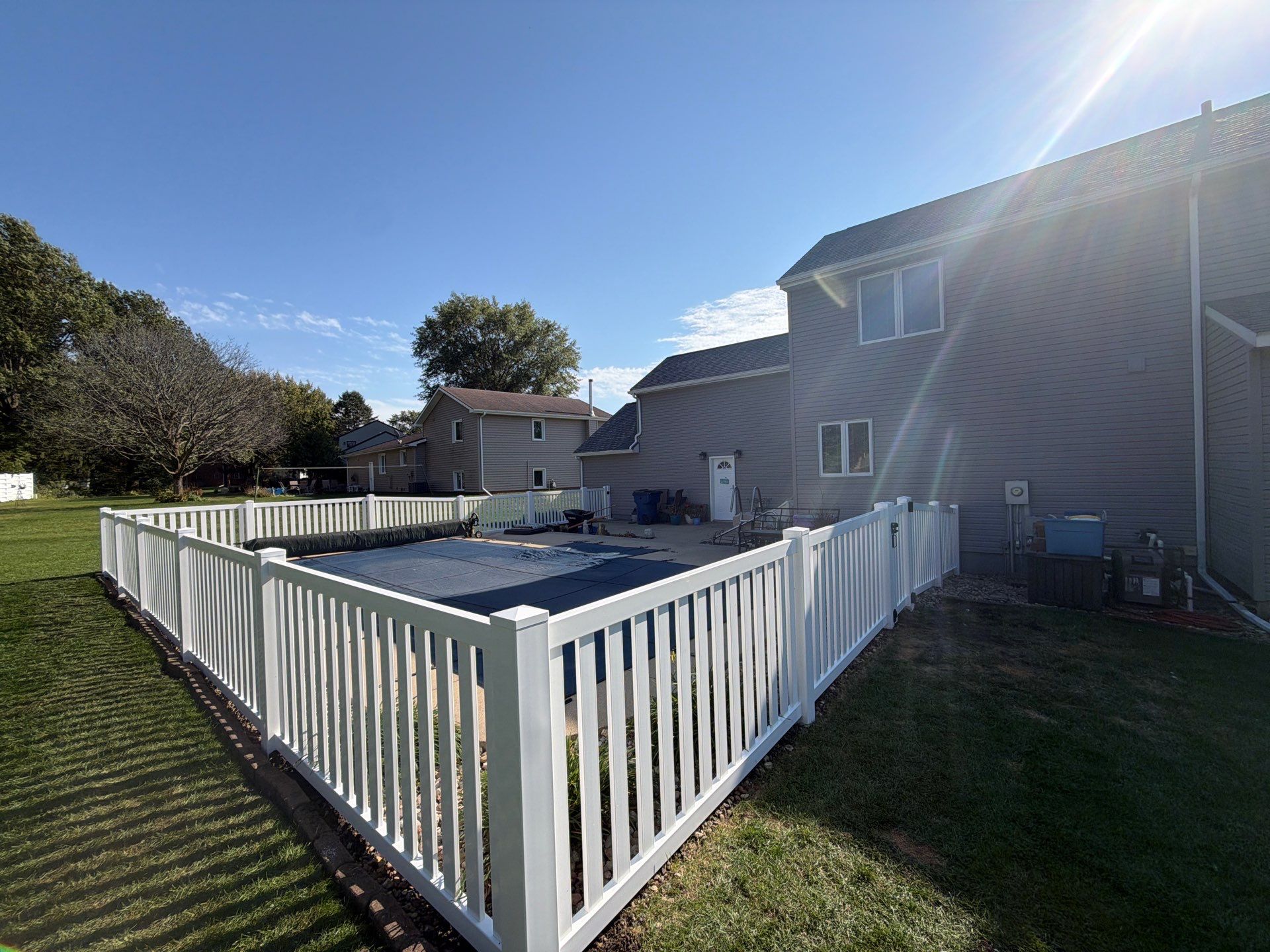White Vinyl Picket Pool Fence Installation in Waterloo, Iowa by Perfect Picket Fence and Stain