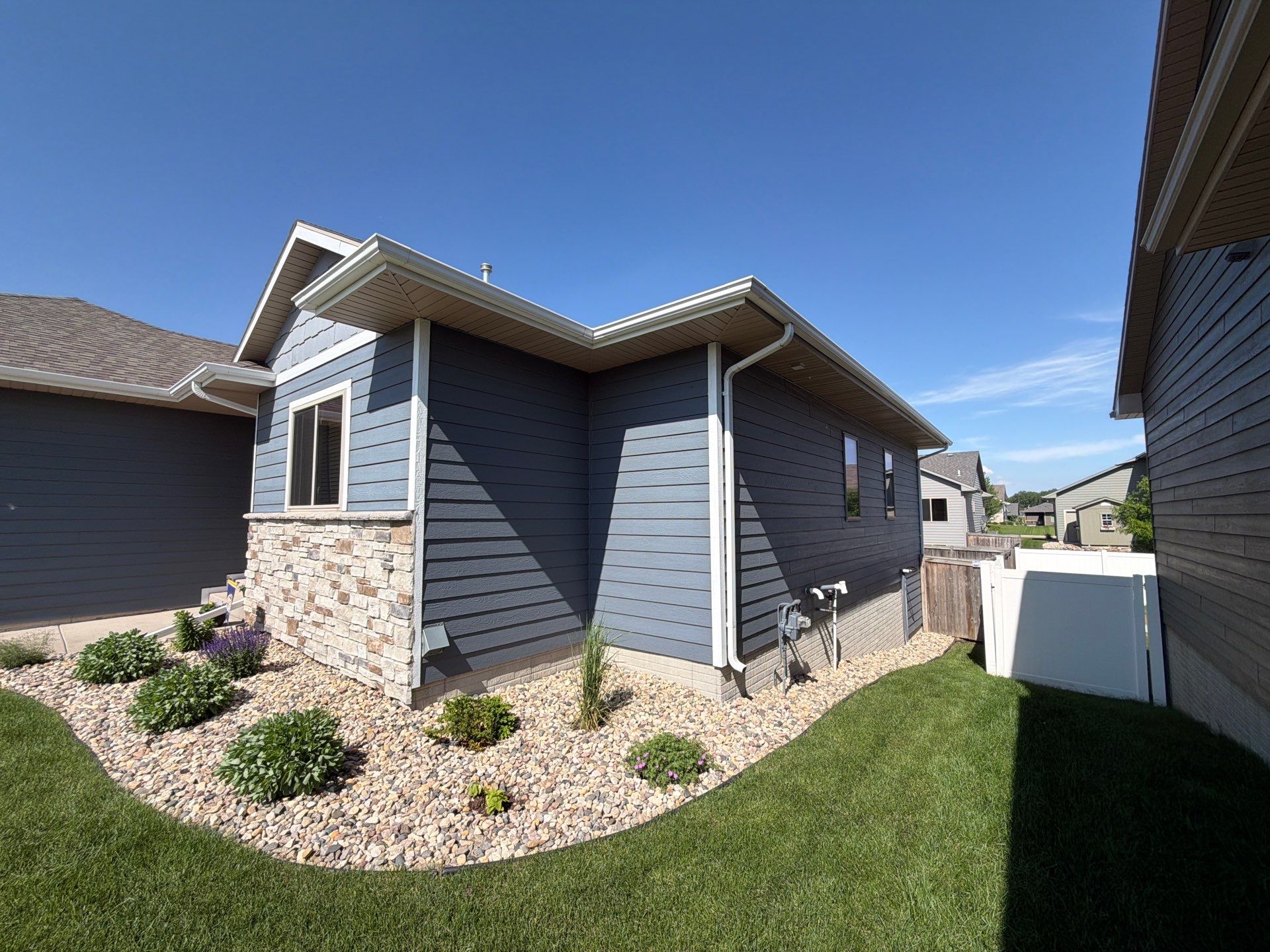 Full Exterior Home Painting on Blue Lap Siding in Sioux Falls by Select Painting, Coatings & Garage Cabinets