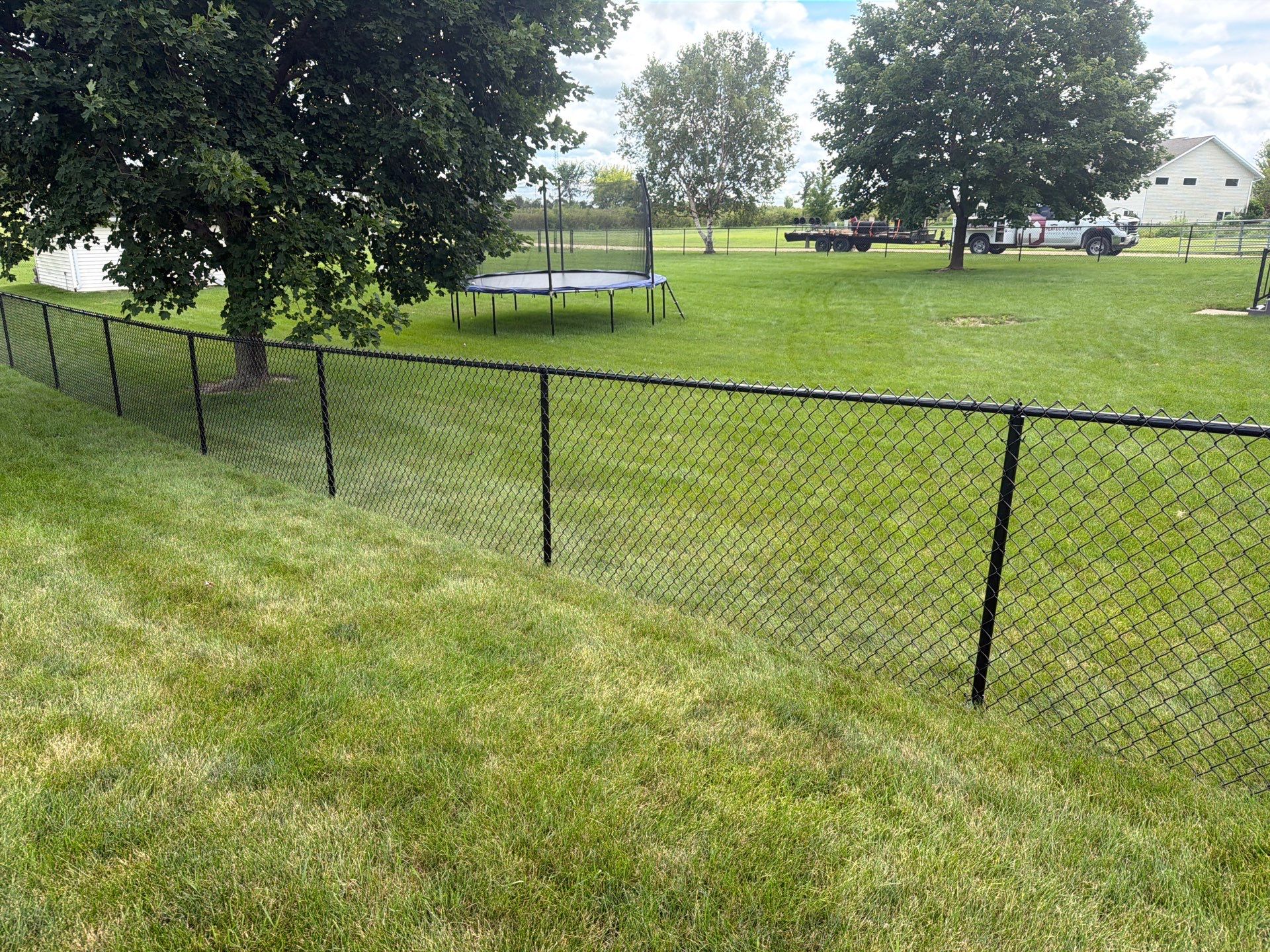 Black Vinyl-Coated Chain Link Fence Installation in Fairbank by Perfect Picket Fence and Stain