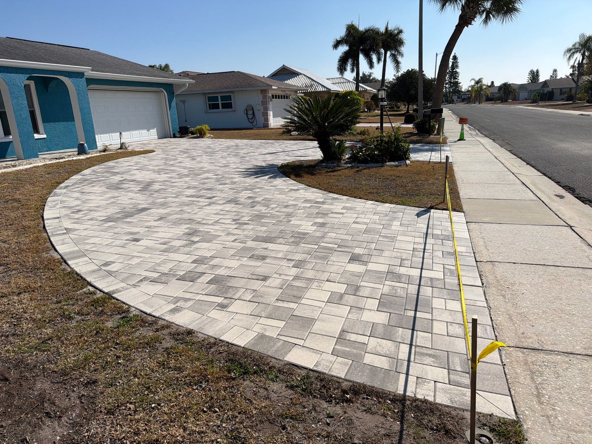 Modern Gray Paver Driveway and Entryway Walkway in Sun City Center by Supreme Paver Experts
