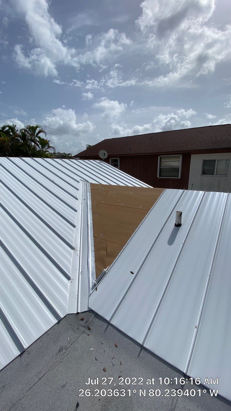 Residential Roofing Installation using 1.5" Nail Strip 24ga Solar White Kynar Coated Standing Seam Metal Panels by Morton Roofing, Inc.