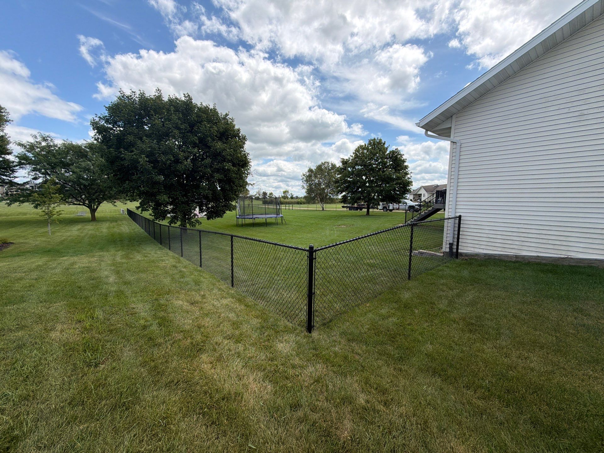 Black Vinyl-Coated Chain Link Fence Installation in Fairbank by Perfect Picket Fence and Stain