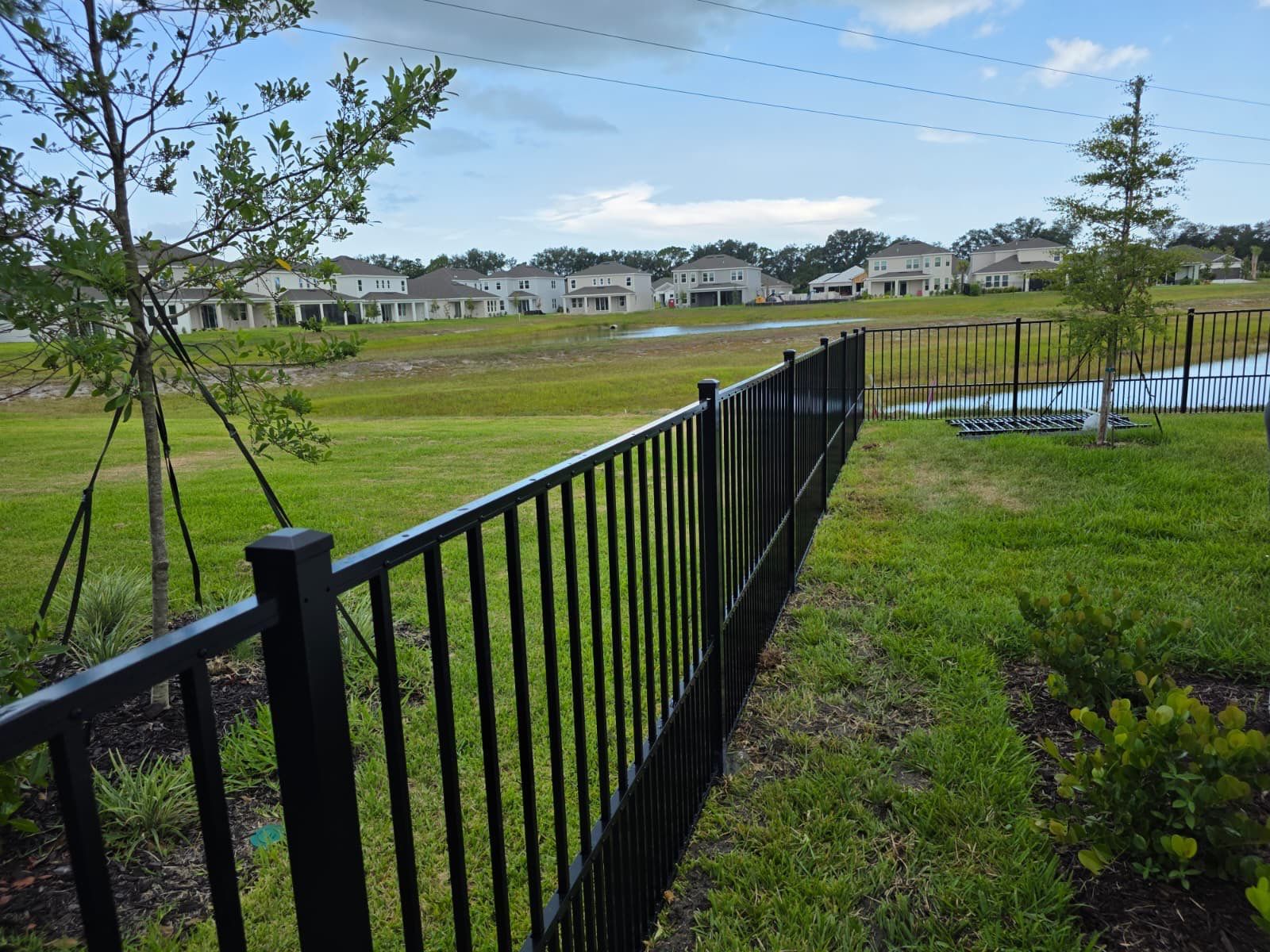 Black Aluminum Puppy Picket Fence Installation in Nokomis by True Fence LLC