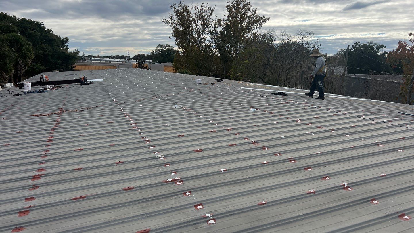 Industrial Metal Roof Restoration With Silicone Coating in Winter Park by CES Roofing