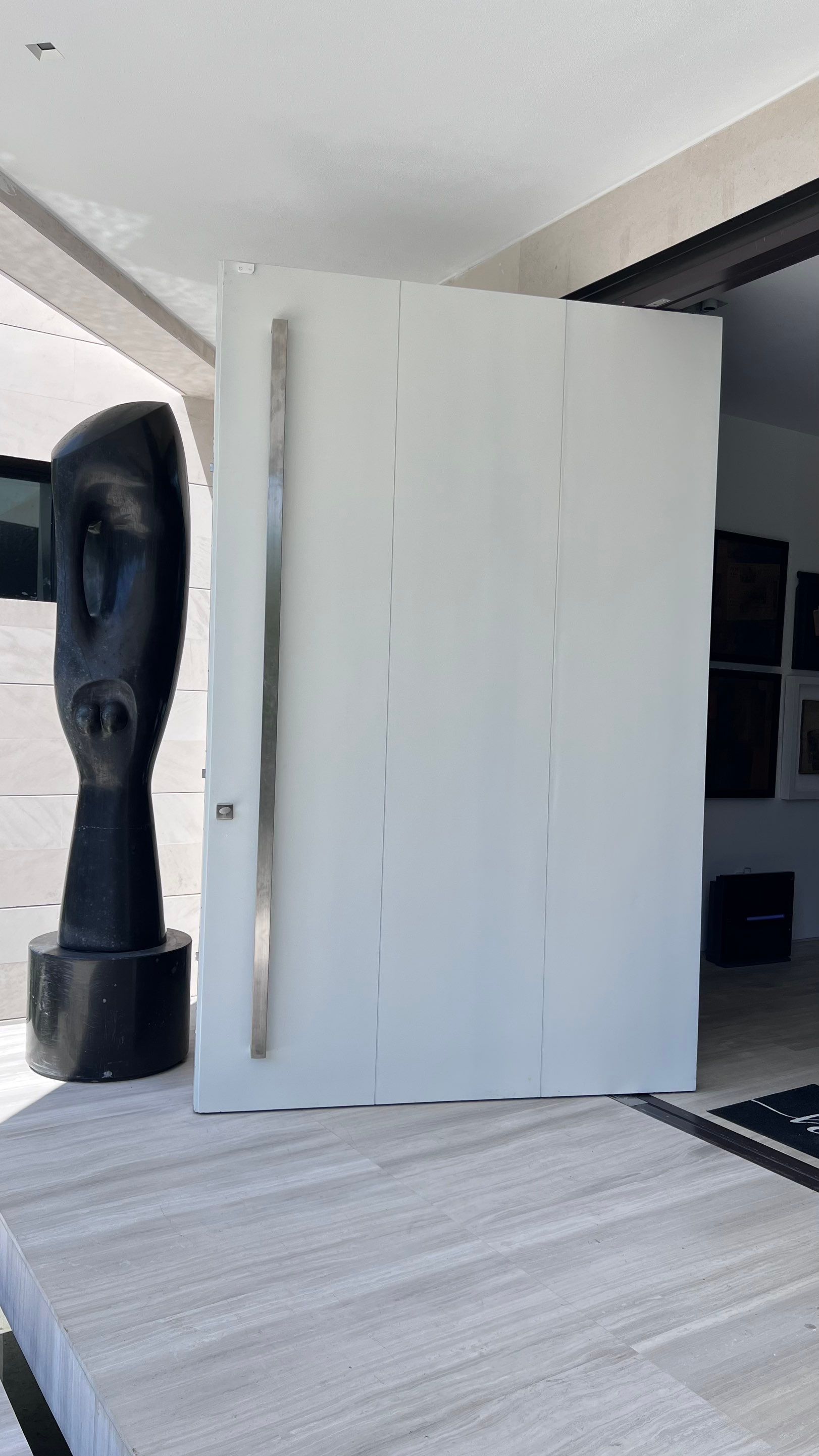 Custom Material Pivot Door installation by Impact Precious Wood Inc.